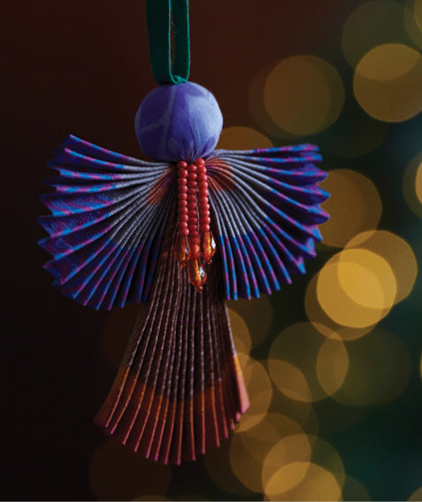 Angel Christmas Ornament made from upcycled saris, featuring pleated arms and body. A sustainable, eco-friendly holiday decoration, embodying recycled fashion and upcycling in festive style.