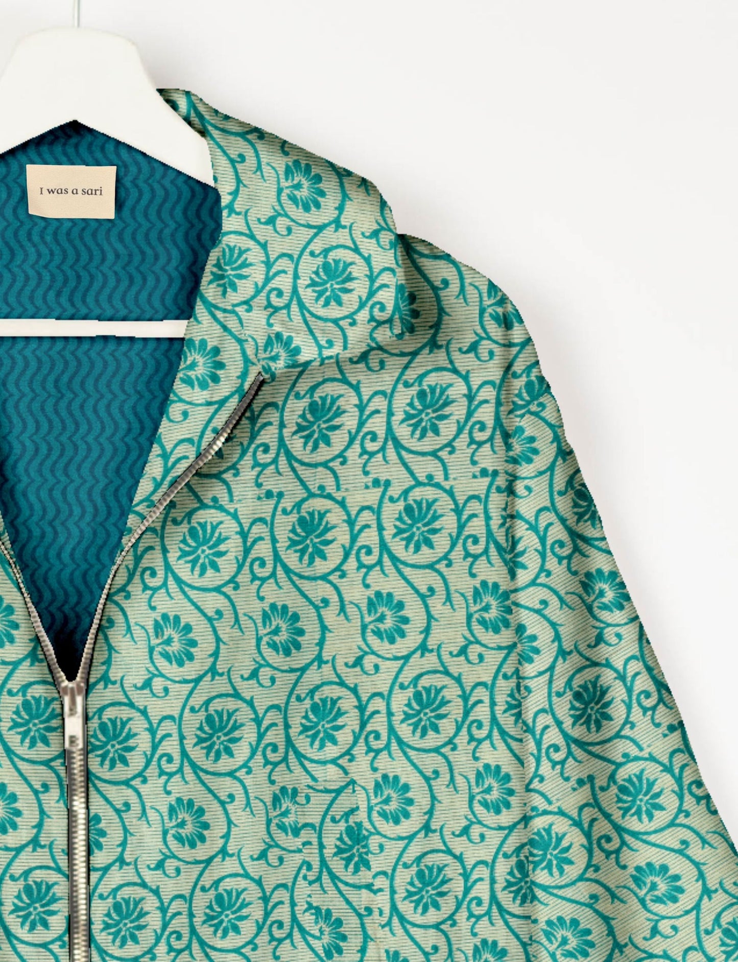 Upcycled Bomber Jacket made from recycled sari materials, featuring a cute cropped shape, elasticated hem and cuffs, and contrast sari print lining. Sustainable apparel promoting eco-friendly fashion and ethical clothing.