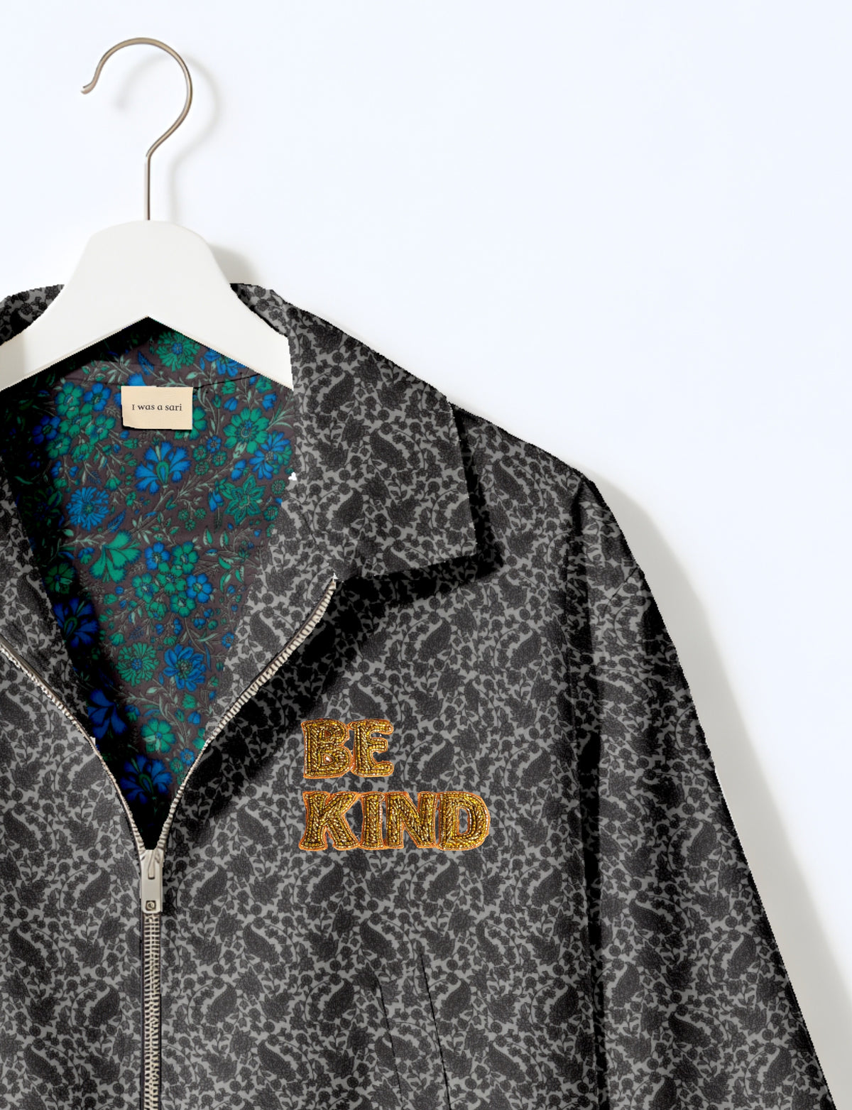 BE KIND Bomber jacket made from upcycled sari fabric with handcrafted Aari embroidery by female artisans.