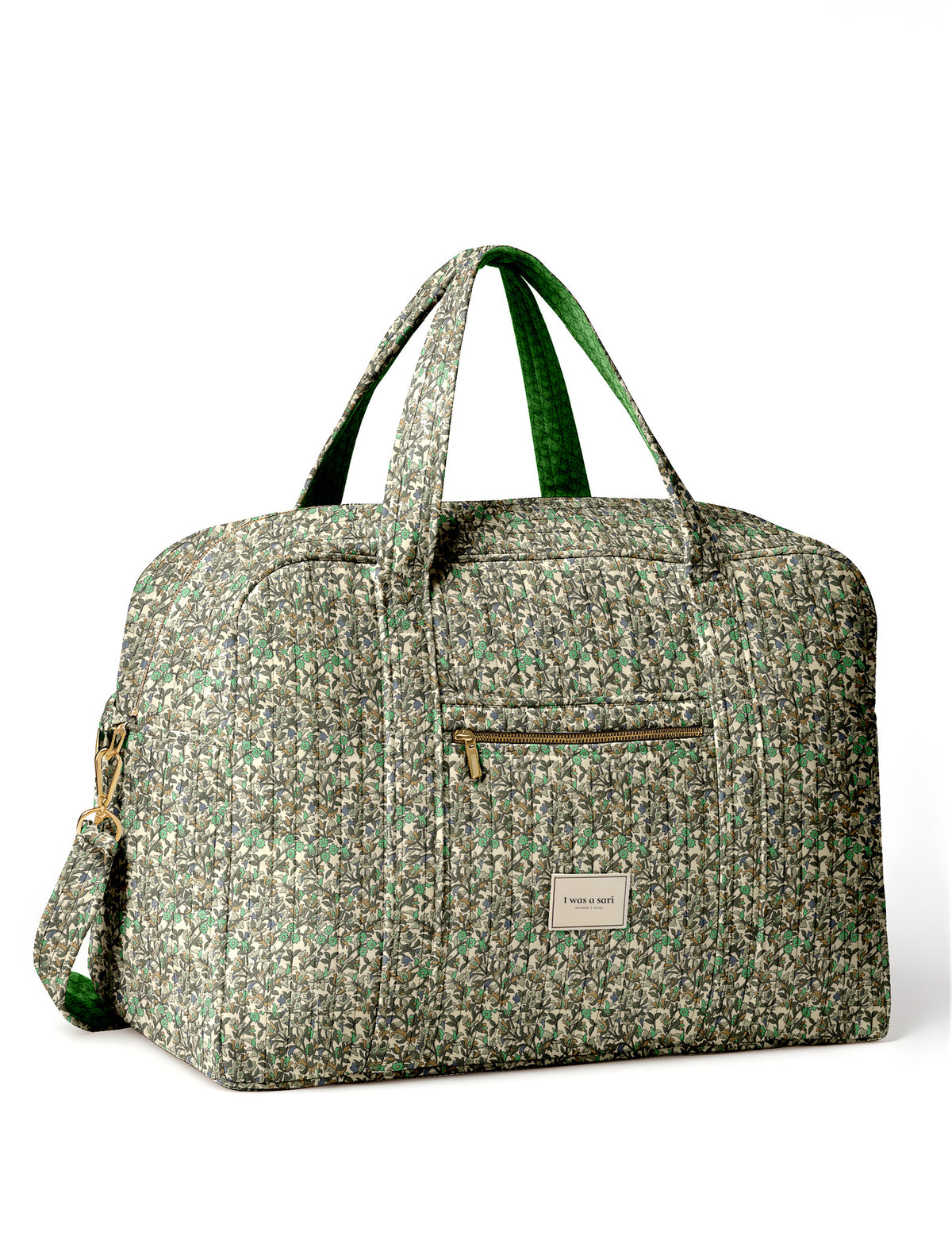 Brown quilted duffle bag with paisley pattern, front zip pocket, dual handles, and label reading "I was a sari"