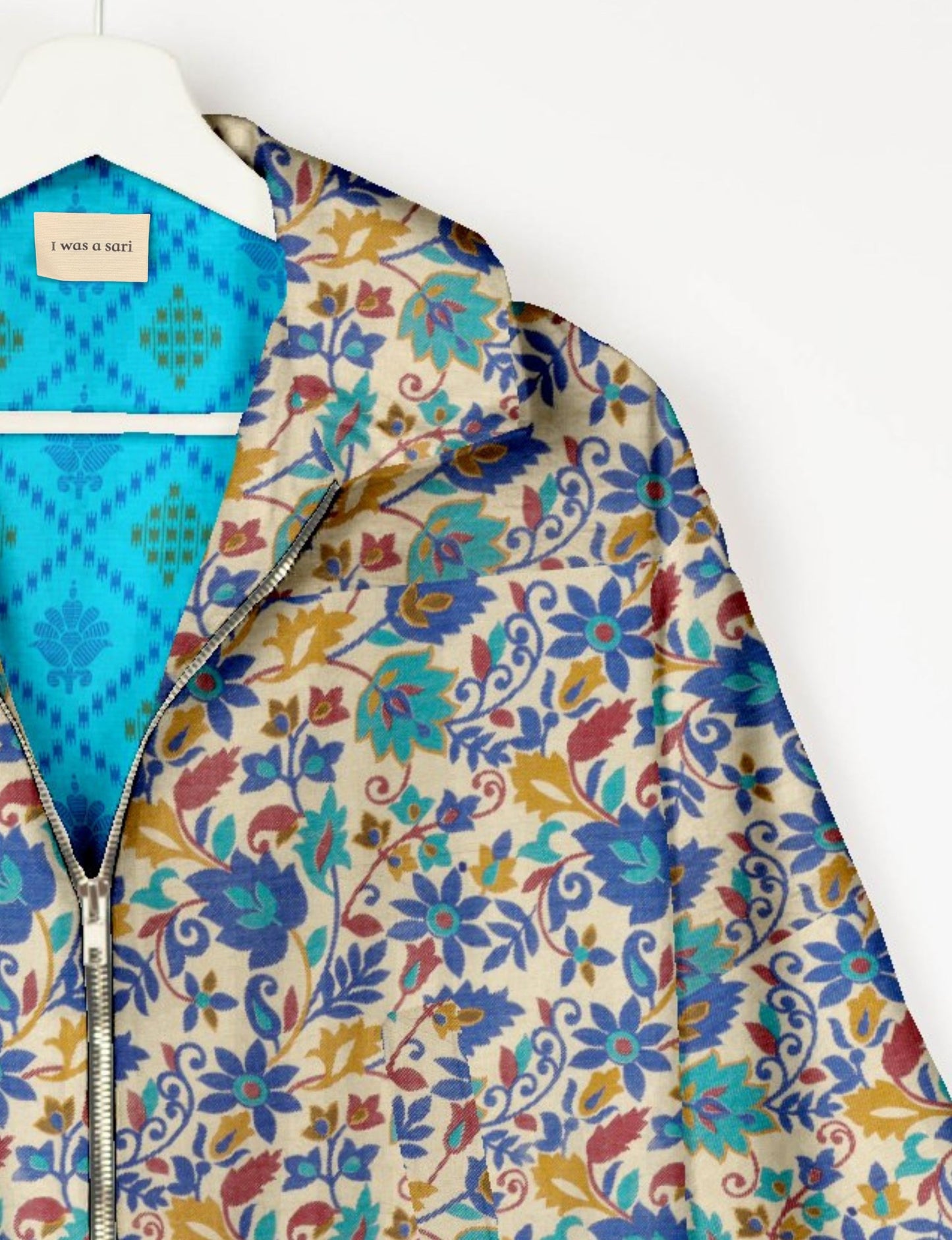 Upcycled Bomber Jacket made from recycled sari materials, featuring a cute cropped shape, elasticated hem and cuffs, and contrast sari print lining. Sustainable apparel promoting eco-friendly fashion and ethical clothing.