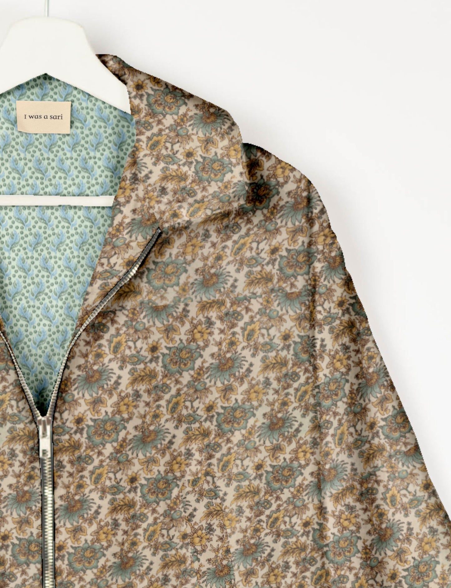 Upcycled Bomber Jacket made from recycled sari materials, featuring a cute cropped shape, elasticated hem and cuffs, and contrast sari print lining. Sustainable apparel promoting eco-friendly fashion and ethical clothing.