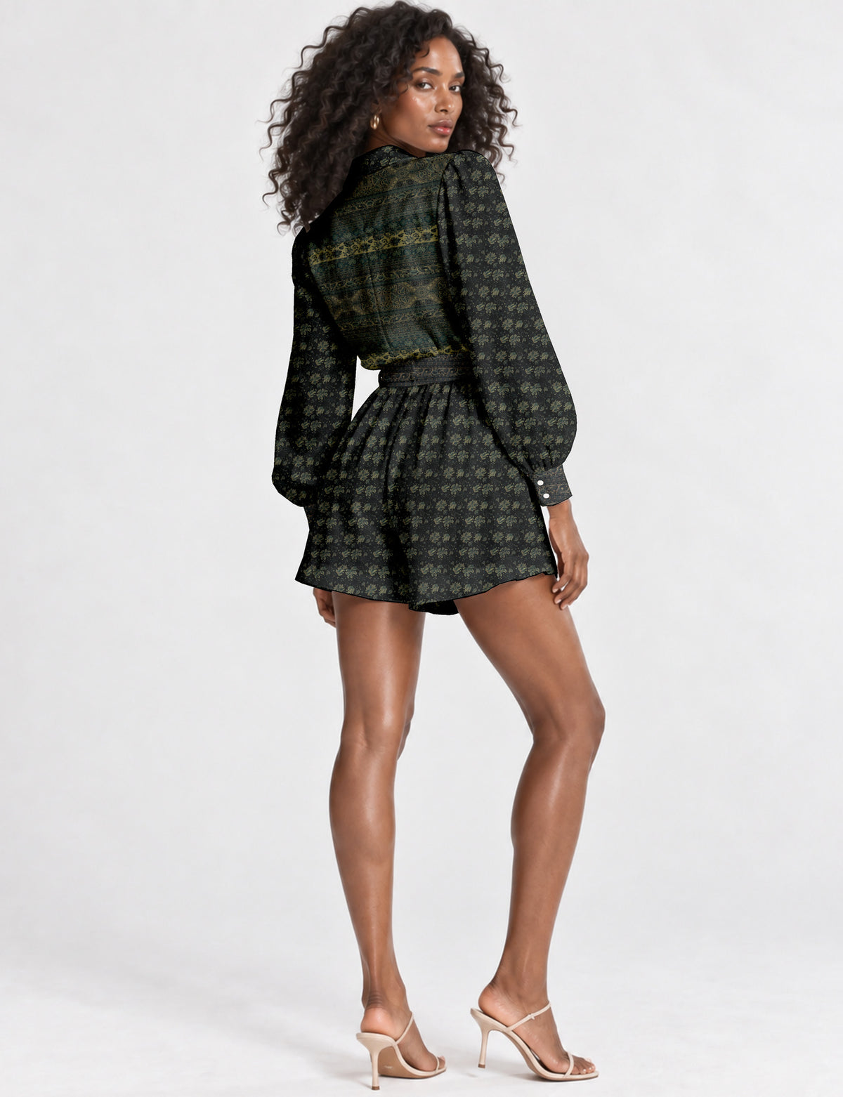 Women’s long sleeve playsuit with wrap-style front, V neckline, notched collar, adjustable waist tie and mid-thigh shorts.