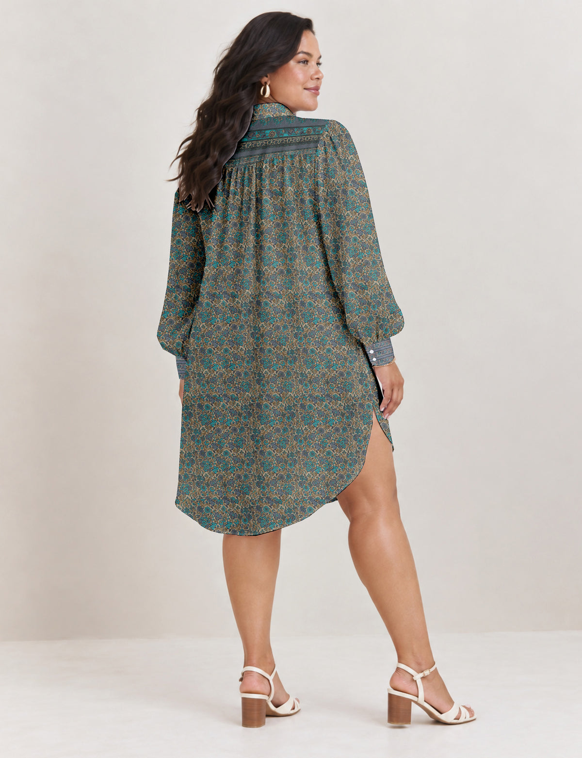 High low shirt with a relaxed fit, button-down front, classic collar, gathered shoulders and full-length blouson sleeves.