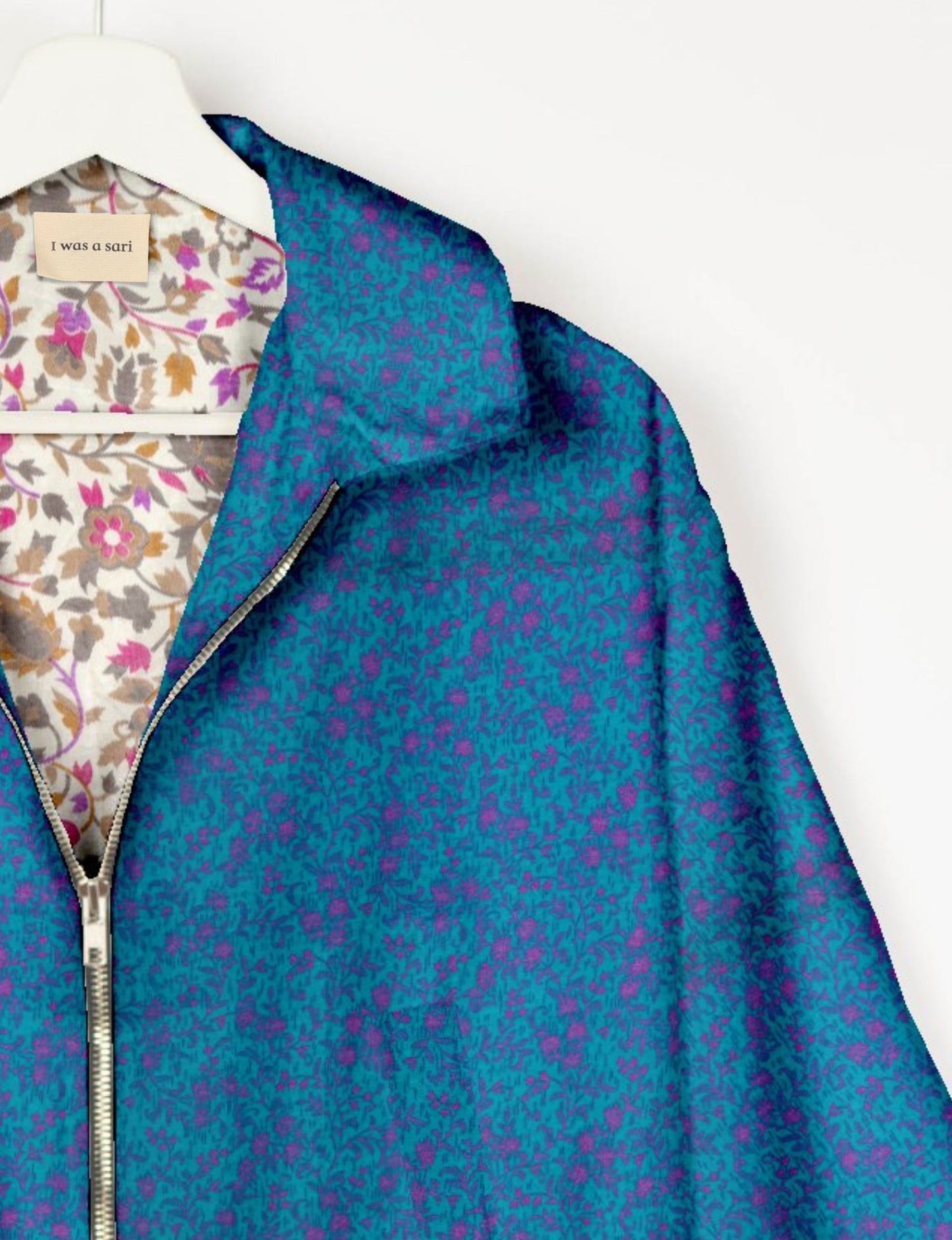 Upcycled Bomber Jacket made from recycled sari materials, featuring a cute cropped shape, elasticated hem and cuffs, and contrast sari print lining. Sustainable apparel promoting eco-friendly fashion and ethical clothing.