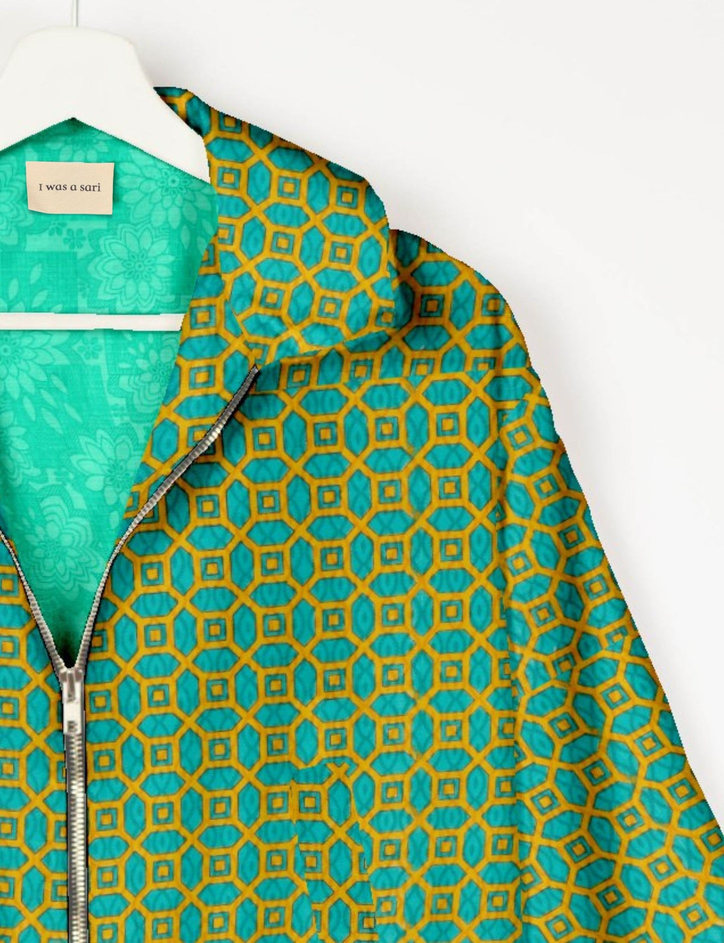 Upcycled Bomber Jacket made from recycled sari materials, featuring a cute cropped shape, elasticated hem and cuffs, and contrast sari print lining. Sustainable apparel promoting eco-friendly fashion and ethical clothing.