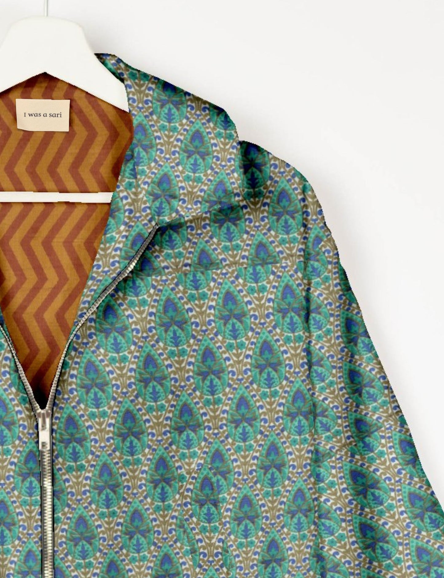 Upcycled Bomber Jacket made from recycled sari materials, featuring a cute cropped shape, elasticated hem and cuffs, and contrast sari print lining. Sustainable apparel promoting eco-friendly fashion and ethical clothing.