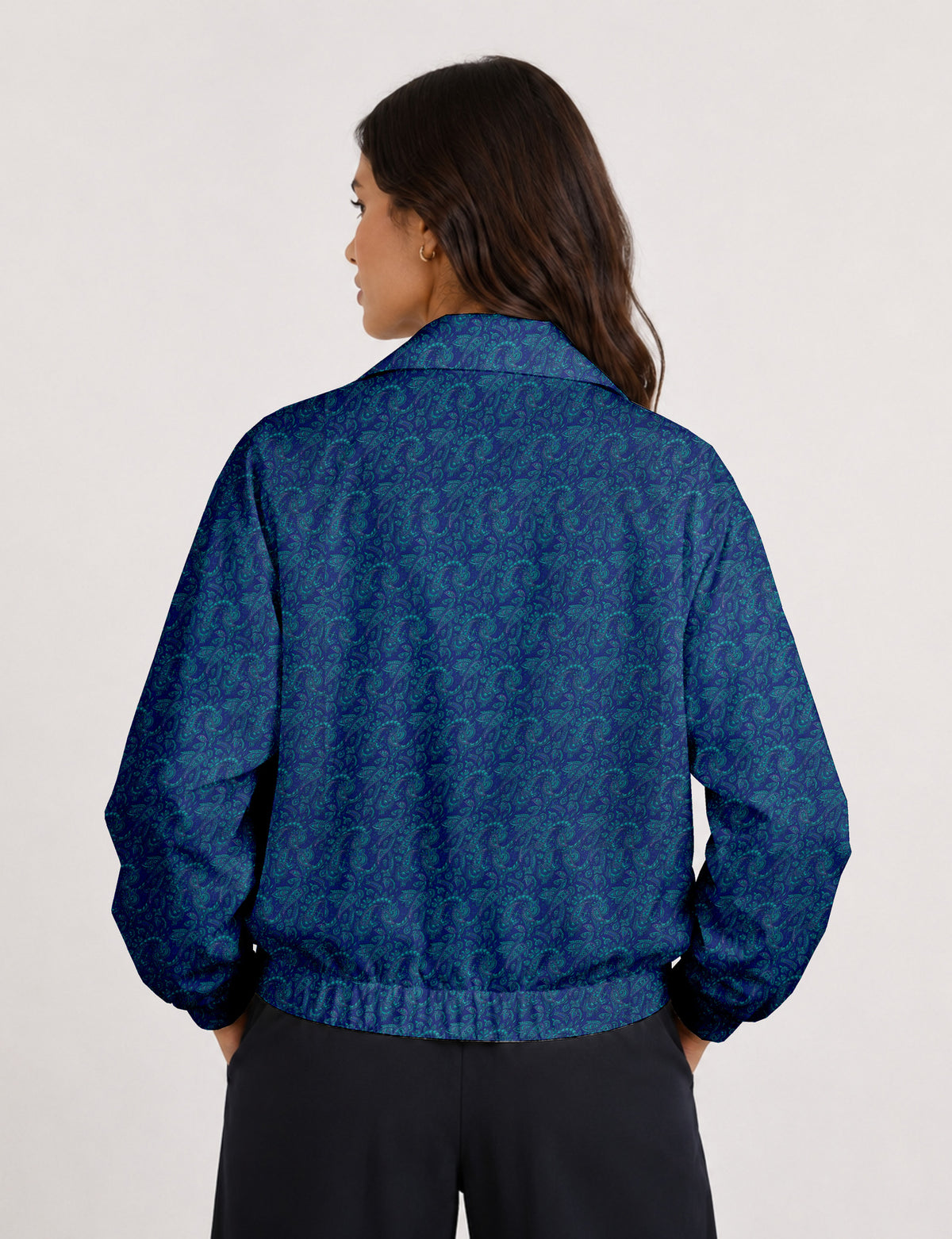Woman wearing a yellow floral bomber jacket with front zipper, elastic cuffs, and side pockets, shown from front view