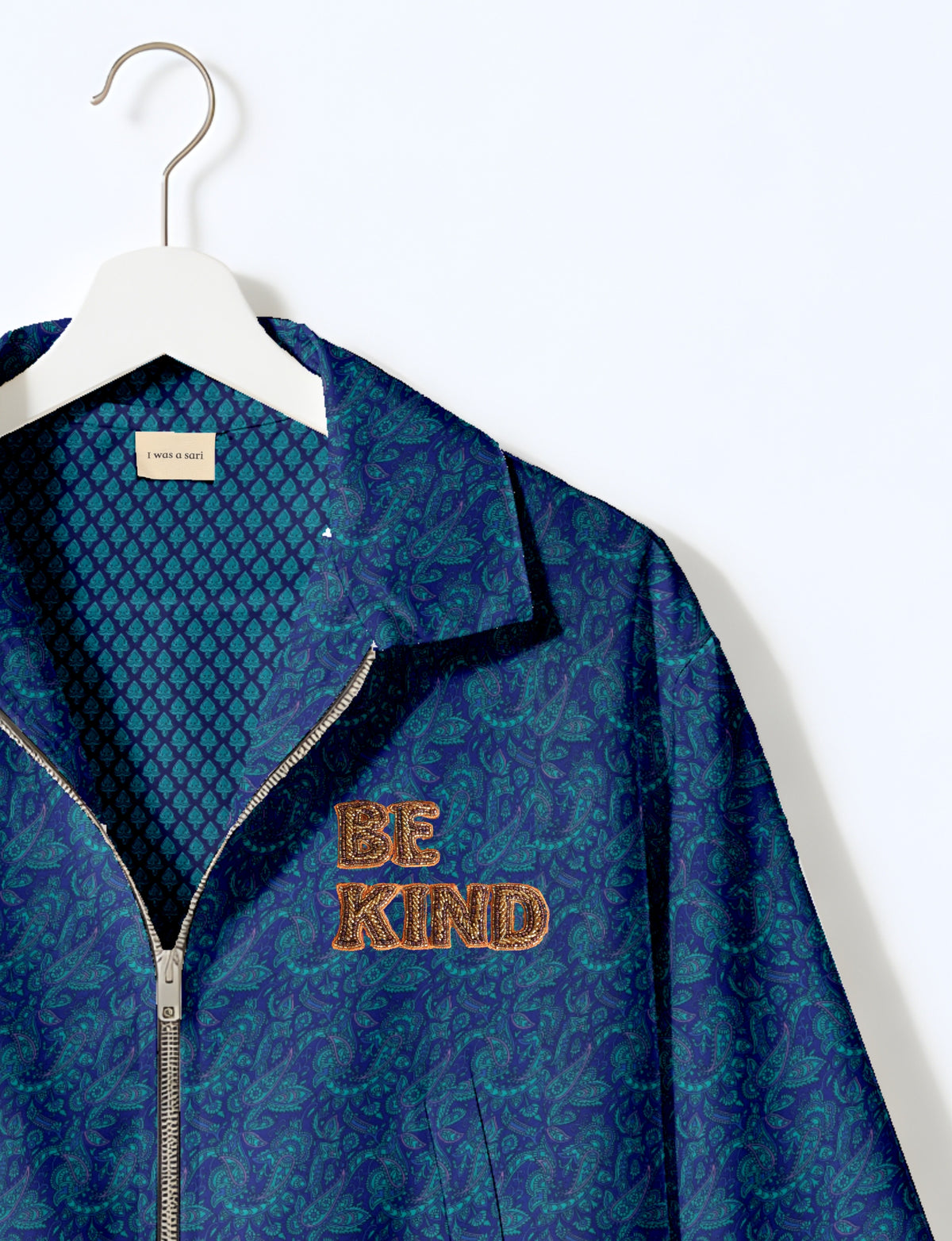 BE KIND Bomber jacket made from upcycled sari fabric with handcrafted Aari embroidery by female artisans.