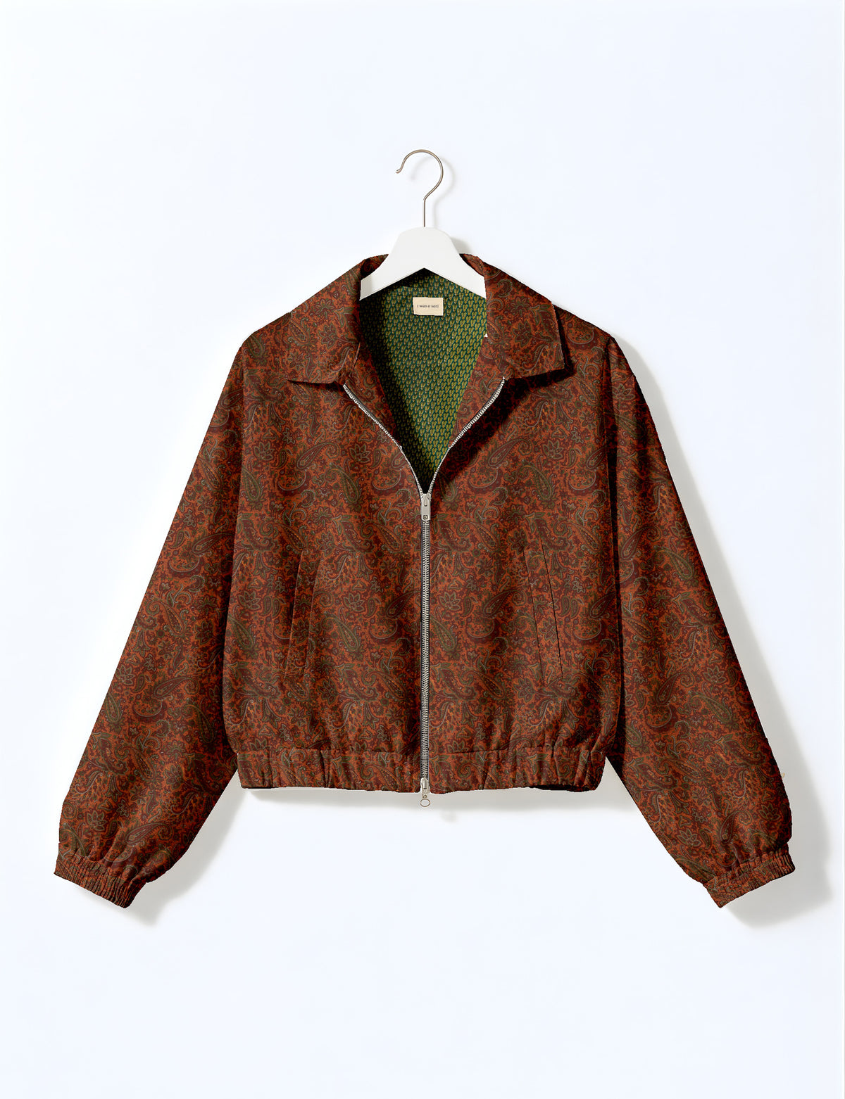 Brown floral bomber jacket with front zipper, elastic cuffs and hem, hanging on white hanger, red floral inner lining visible