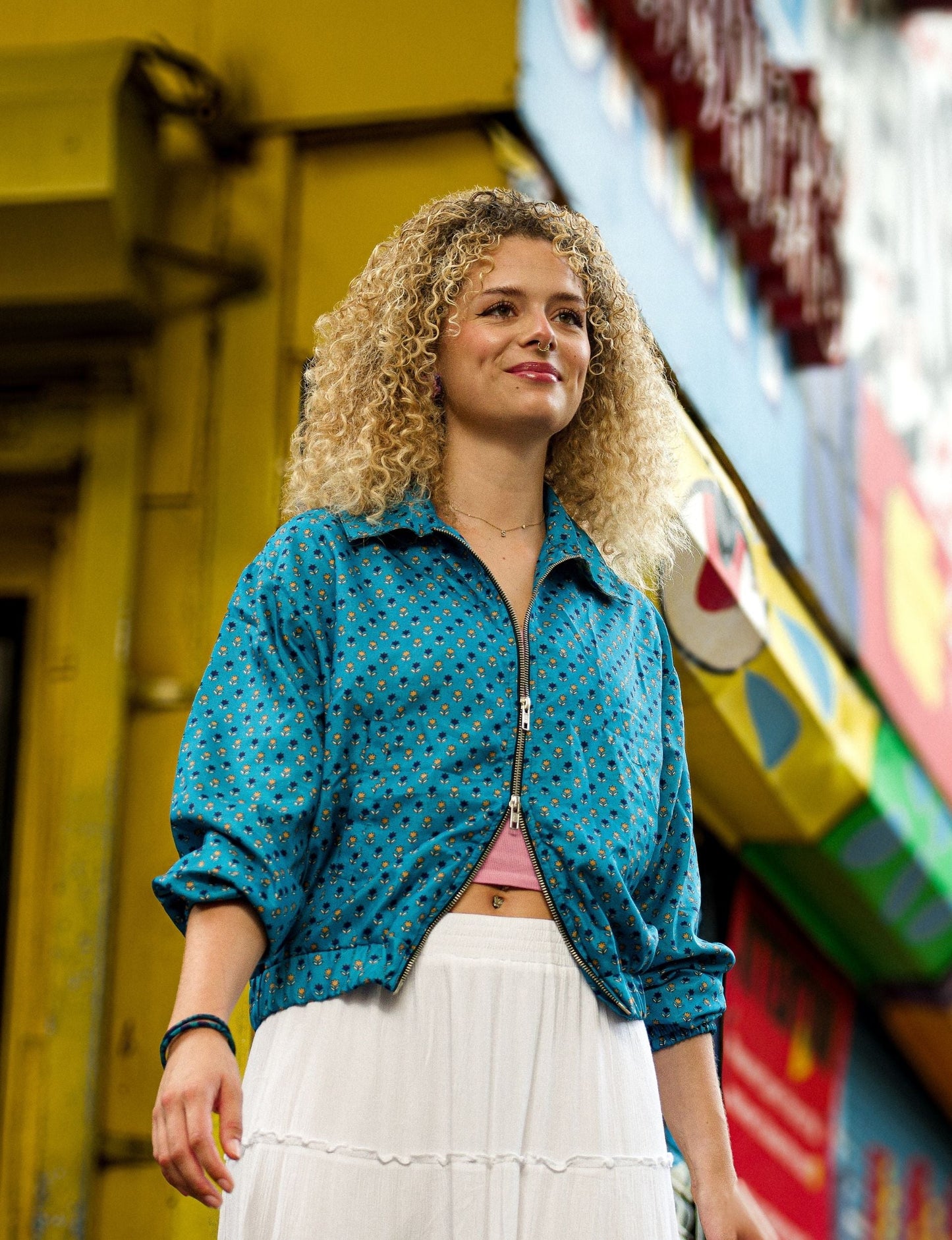 Upcycled Bomber Jacket made from recycled sari materials, featuring a cute cropped shape, elasticated hem and cuffs, and contrast sari print lining. Sustainable apparel promoting eco-friendly fashion and ethical clothing.