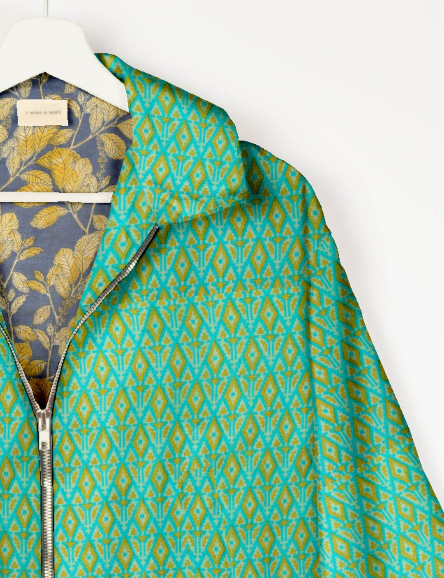 Upcycled Bomber Jacket made from recycled sari materials, featuring a cute cropped shape, elasticated hem and cuffs, and contrast sari print lining. Sustainable apparel promoting eco-friendly fashion and ethical clothing.