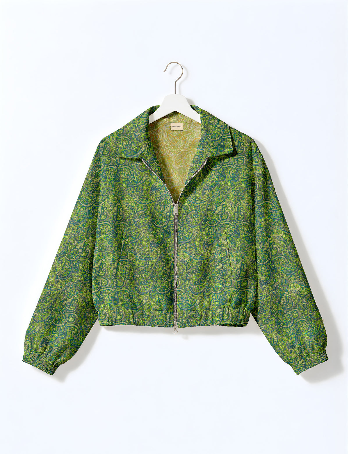 Woman wearing a yellow floral bomber jacket with front zipper, elastic cuffs, and side pockets, shown from front view
