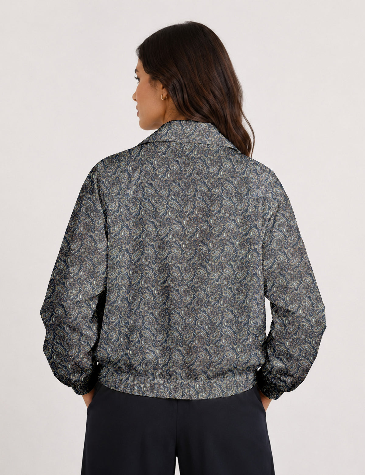 Woman wearing a yellow floral bomber jacket with front zipper, elastic cuffs, and side pockets, shown from front view