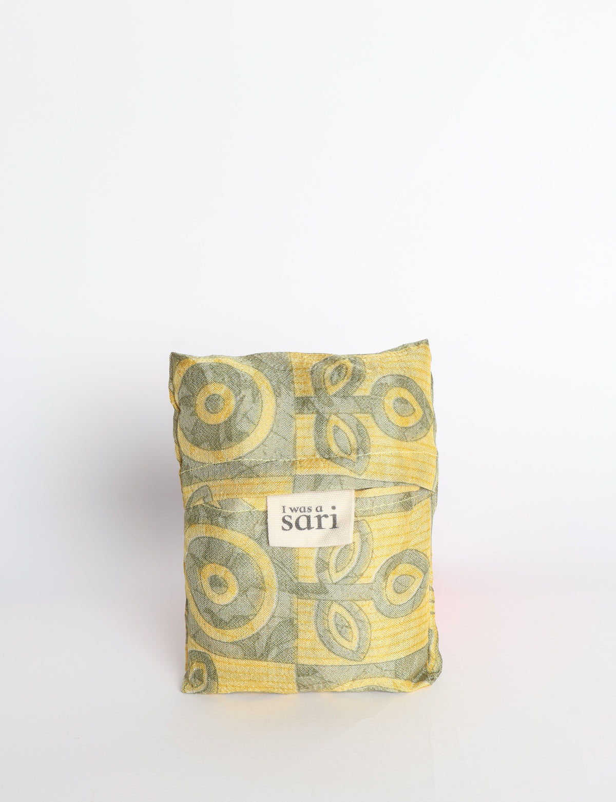 Blue reusable bag with multicolor tropical floral pattern folded with "I was a sari" label visible on front