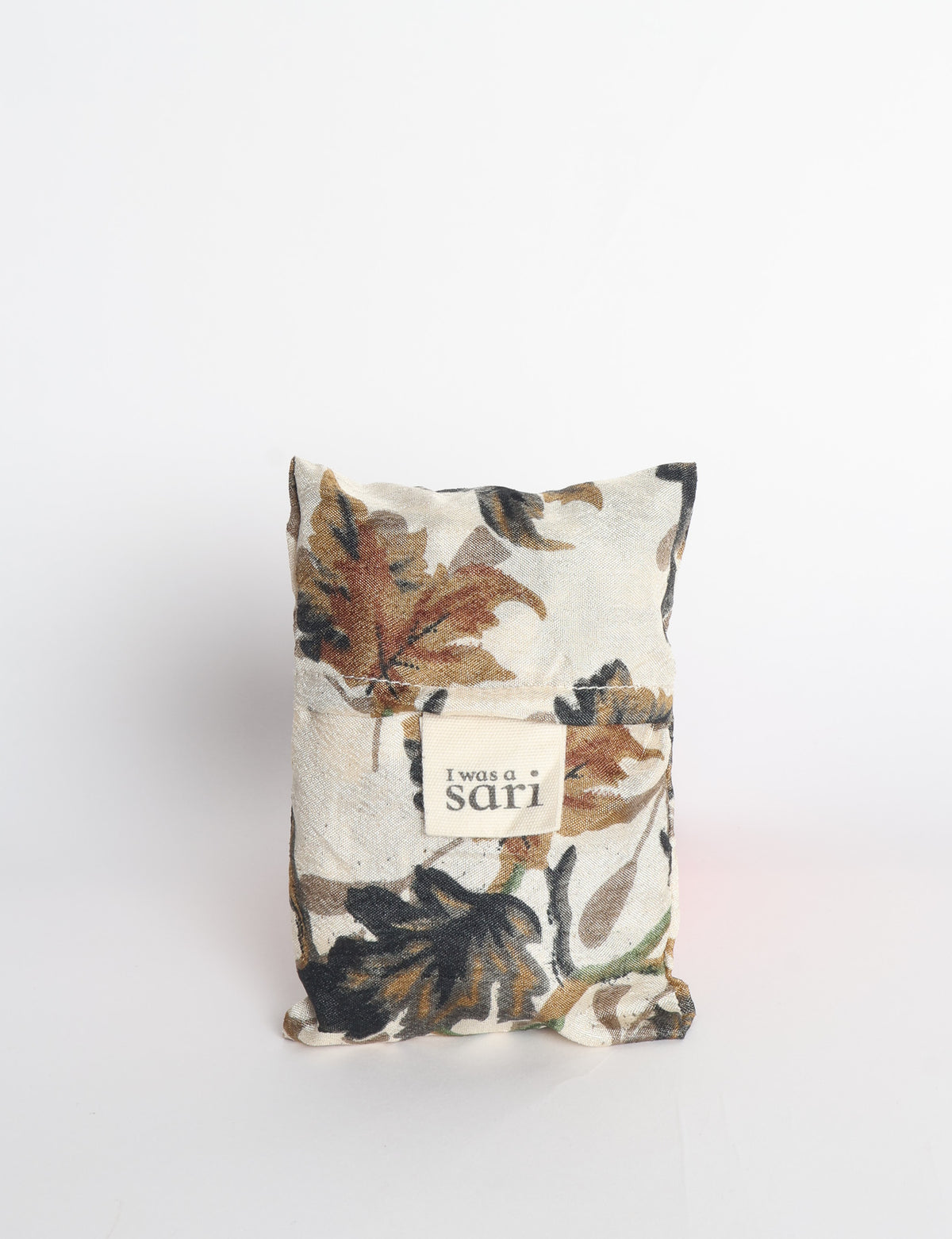 Blue reusable bag with multicolor tropical floral pattern folded with "I was a sari" label visible on front