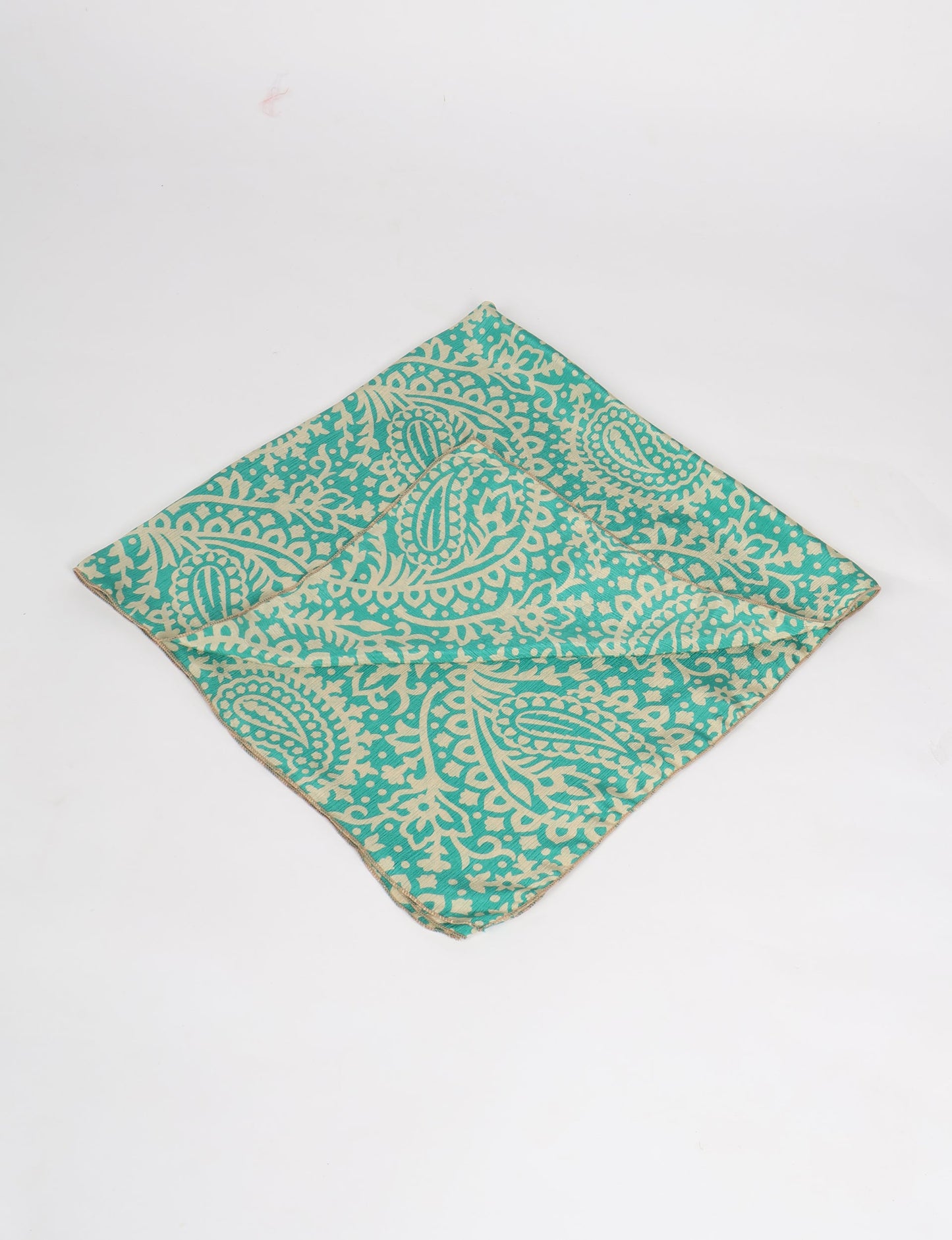 A delicately handcrafted wrap made from recycled sari offcuts, blending sustainable fashion with conscious design. This eco-friendly product showcases the beauty of upcycling and green fashion, making it a perfect accessory for those supporting circular fashion and products made from textile waste.