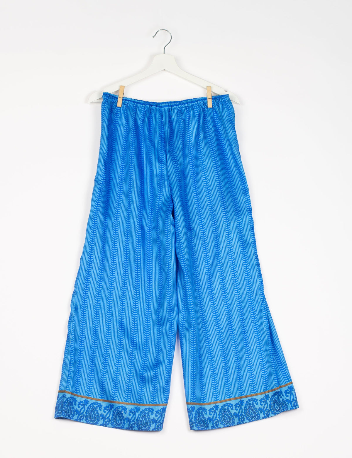 Step into sustainable fashion with our Palazzo Pants – a harmonious blend of Indian and Italian influences. These wide-legged pants, made from upcycled saris, offer comfort with an all-around elastic waist and a stylish flared leg. Make a statement with eco-friendly, chic palazzo pants that redefine ethical clothing.