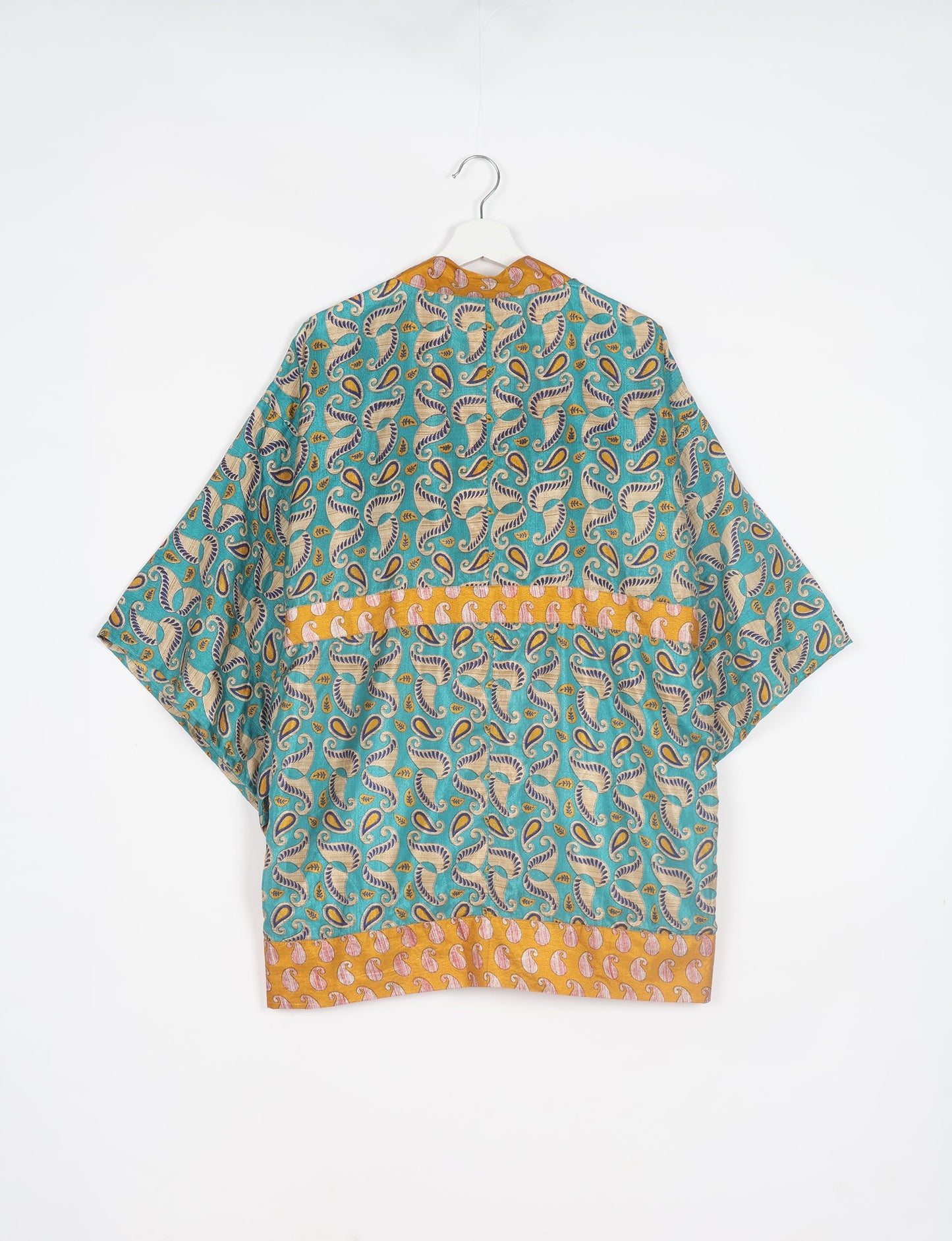 Radiant and sustainably crafted KIMONO with humble beginnings from the streets of India. Versatile and eco-friendly layering piece for casual trousers, swimwear, or our spaghetti strap dress. Embrace conscious fashion and sustainable style with this unique and culturally inspired kimono, sure to invite compliments.