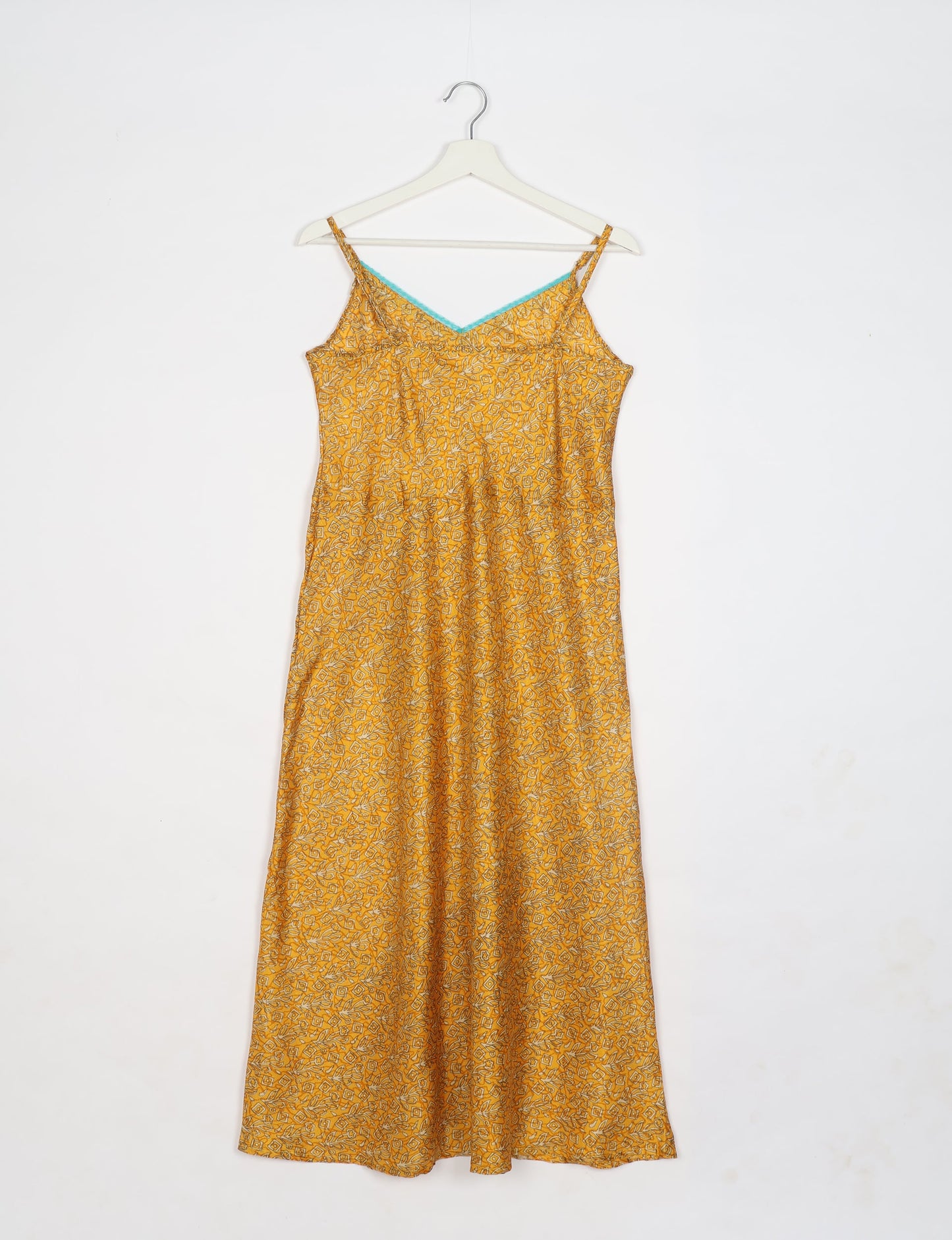 Spaghetti strap dress made from sustainable materials, embodying ethical fashion principles. Ideal for eco-friendly travelers seeking laid-back style.
