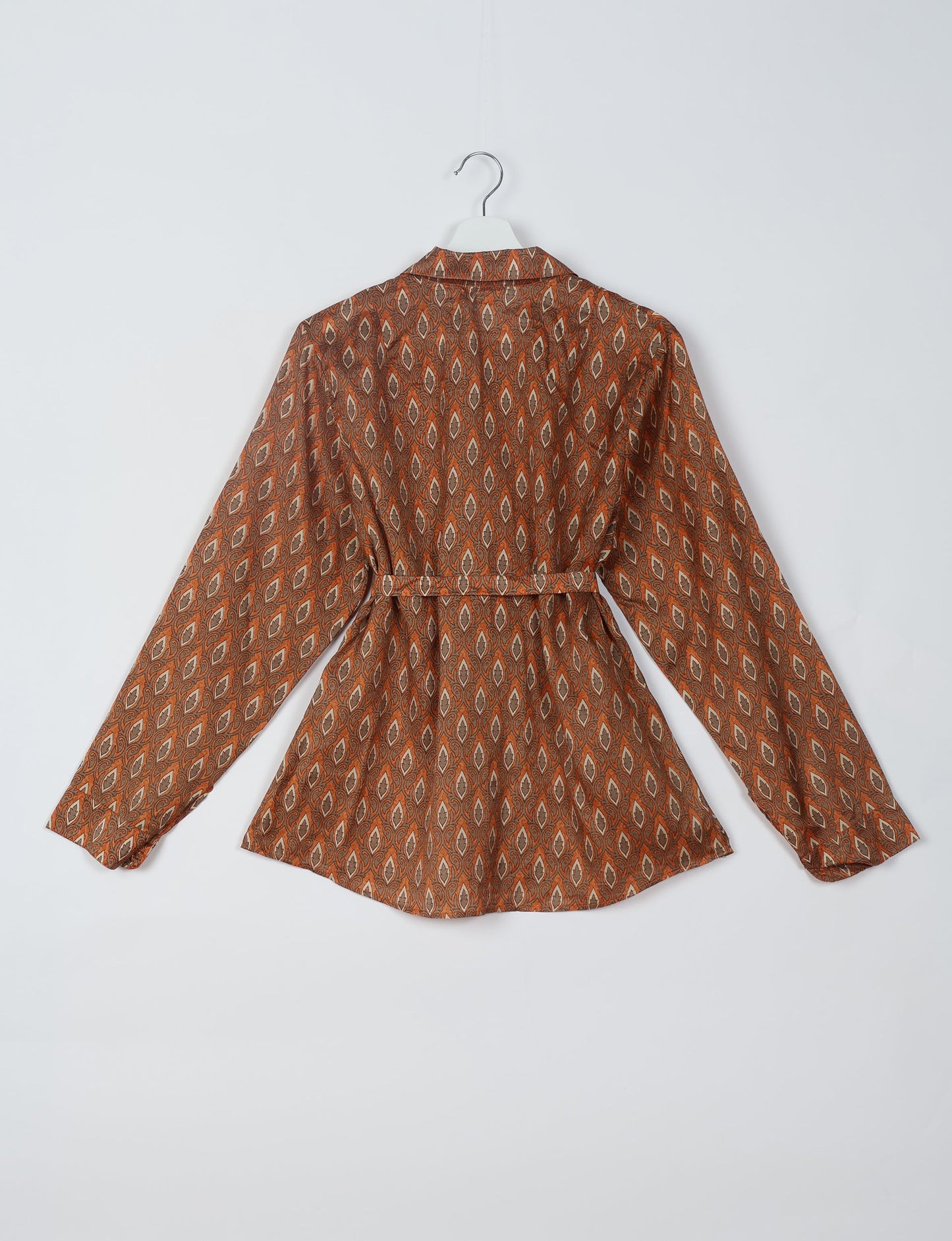 Experience sustainable fashion with our classic slim-fit shirt, crafted with ethical and green values. The shirt, designed for minimal waste, features a tie-up waist belt or neck tie, semi-spread collar, and regular shirt cuffs. Versatile and eco-friendly, wear it tucked in, unbuttoned over a tank top, or knotted at the waist for a unique style.