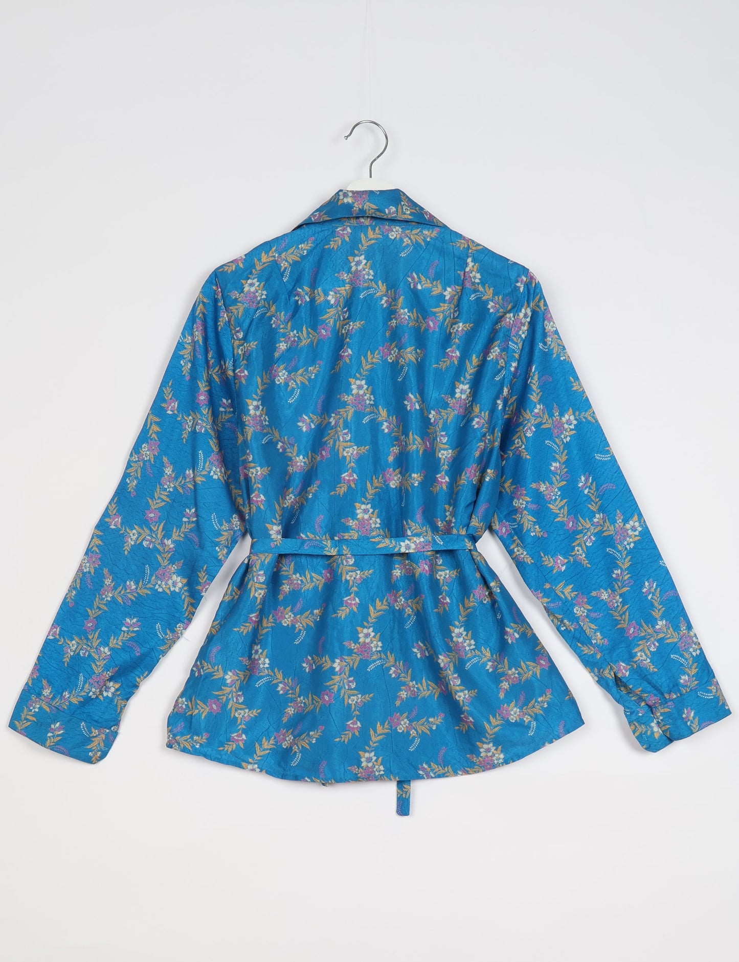 Experience sustainable fashion with our classic slim-fit shirt, crafted with ethical and green values. The shirt, designed for minimal waste, features a tie-up waist belt or neck tie, semi-spread collar, and regular shirt cuffs. Versatile and eco-friendly, wear it tucked in, unbuttoned over a tank top, or knotted at the waist for a unique style.