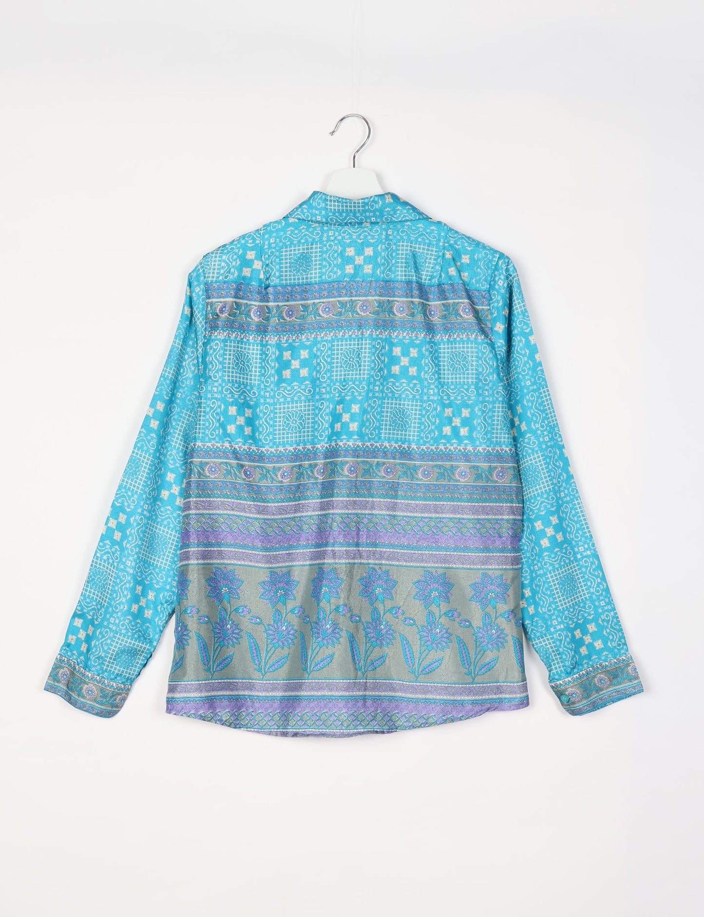 Experience sustainable fashion with our classic slim-fit shirt, crafted with ethical and green values. The shirt, designed for minimal waste, features a tie-up waist belt or neck tie, semi-spread collar, and regular shirt cuffs. Versatile and eco-friendly, wear it tucked in, unbuttoned over a tank top, or knotted at the waist for a unique style.