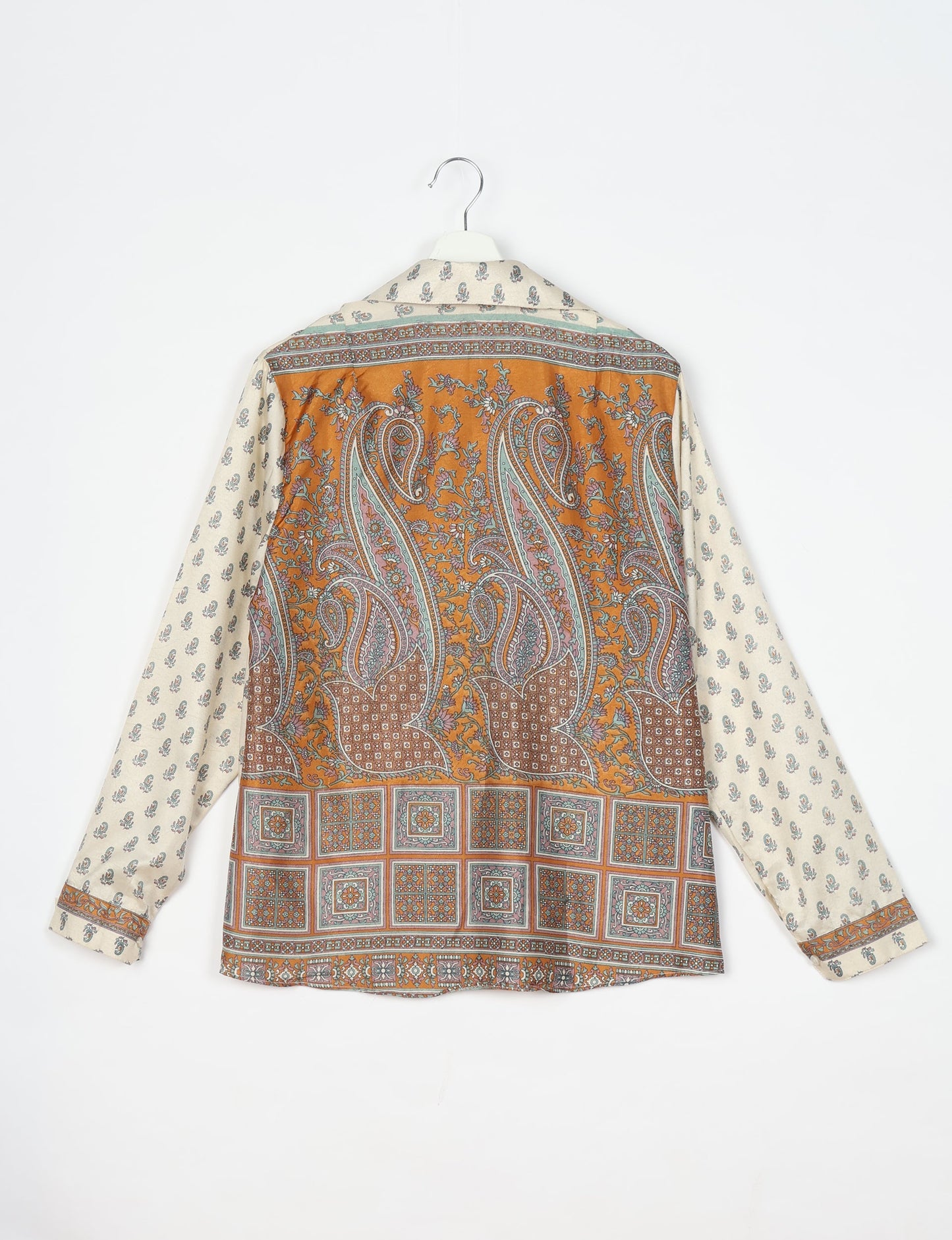 Experience sustainable fashion with our classic slim-fit shirt, crafted with ethical and green values. The shirt, designed for minimal waste, features a tie-up waist belt or neck tie, semi-spread collar, and regular shirt cuffs. Versatile and eco-friendly, wear it tucked in, unbuttoned over a tank top, or knotted at the waist for a unique style.