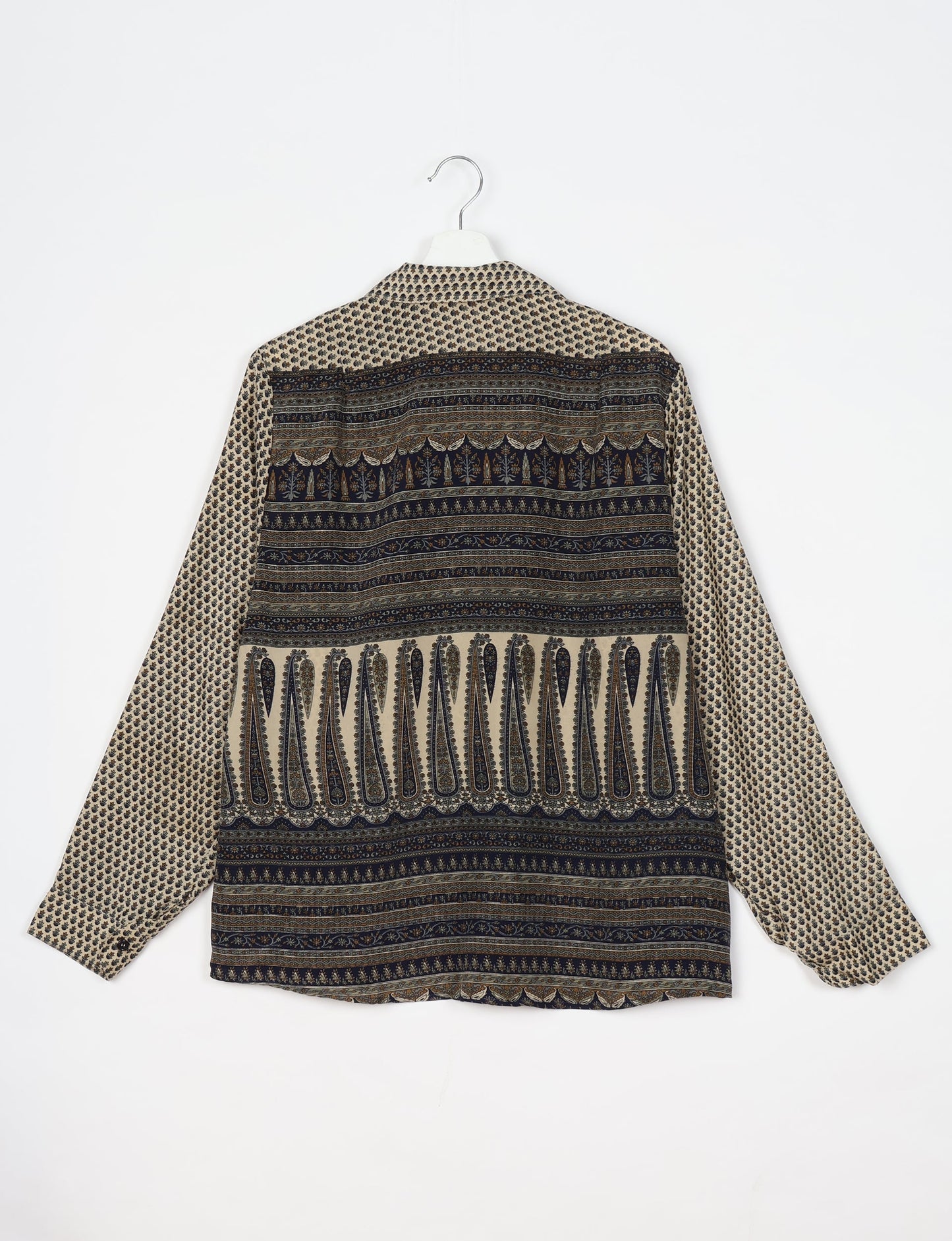 Experience sustainable fashion with our classic slim-fit shirt, crafted with ethical and green values. The shirt, designed for minimal waste, features a tie-up waist belt or neck tie, semi-spread collar, and regular shirt cuffs. Versatile and eco-friendly, wear it tucked in, unbuttoned over a tank top, or knotted at the waist for a unique style.