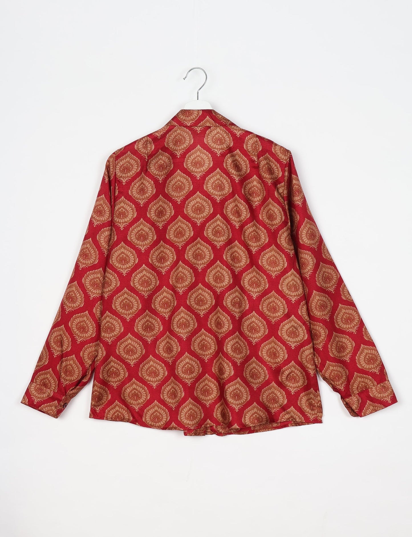 Experience sustainable fashion with our classic slim-fit shirt, crafted with ethical and green values. The shirt, designed for minimal waste, features a tie-up waist belt or neck tie, semi-spread collar, and regular shirt cuffs. Versatile and eco-friendly, wear it tucked in, unbuttoned over a tank top, or knotted at the waist for a unique style.