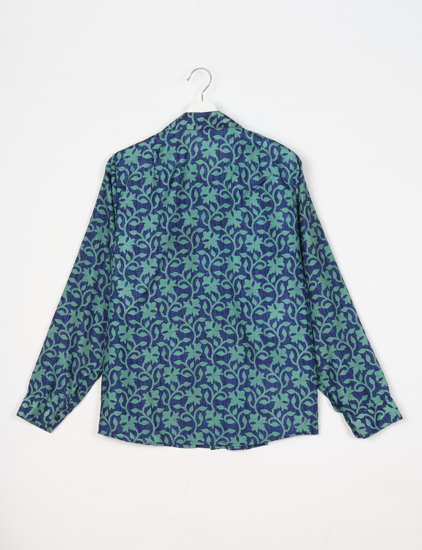 Experience sustainable fashion with our classic slim-fit shirt, crafted with ethical and green values. The shirt, designed for minimal waste, features a tie-up waist belt or neck tie, semi-spread collar, and regular shirt cuffs. Versatile and eco-friendly, wear it tucked in, unbuttoned over a tank top, or knotted at the waist for a unique style.