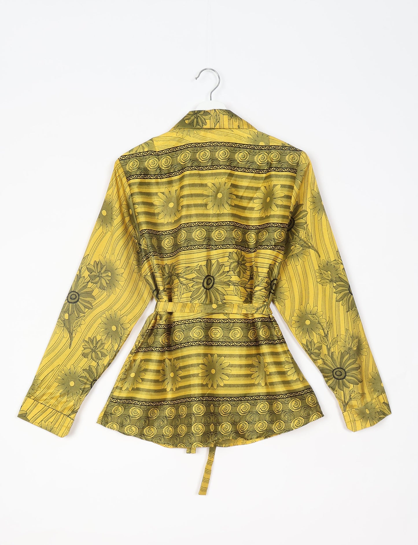 Experience sustainable fashion with our classic slim-fit shirt, crafted with ethical and green values. The shirt, designed for minimal waste, features a tie-up waist belt or neck tie, semi-spread collar, and regular shirt cuffs. Versatile and eco-friendly, wear it tucked in, unbuttoned over a tank top, or knotted at the waist for a unique style.