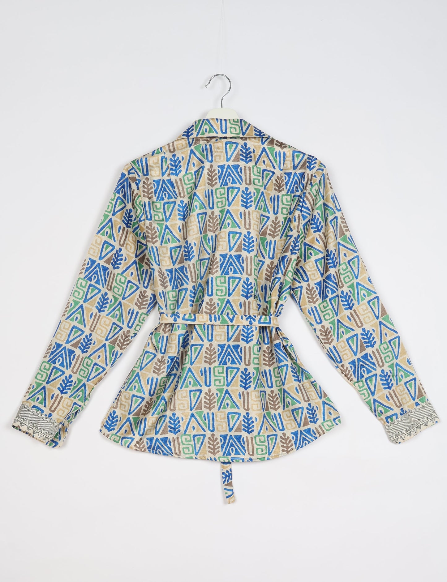 Experience sustainable fashion with our classic slim-fit shirt, crafted with ethical and green values. The shirt, designed for minimal waste, features a tie-up waist belt or neck tie, semi-spread collar, and regular shirt cuffs. Versatile and eco-friendly, wear it tucked in, unbuttoned over a tank top, or knotted at the waist for a unique style.