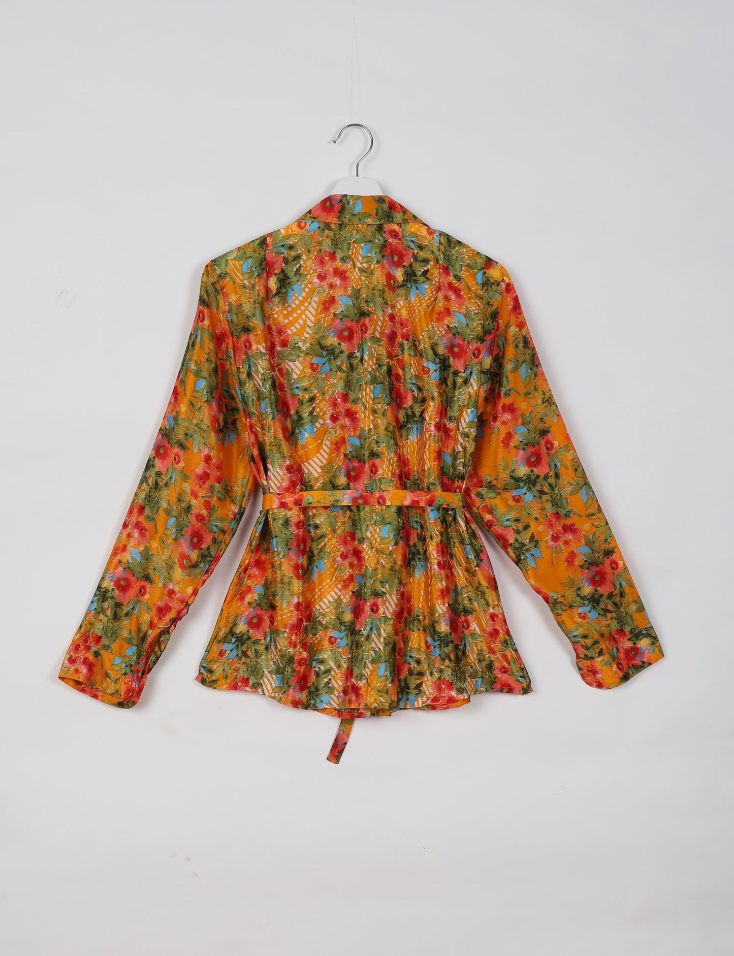 Experience sustainable fashion with our classic slim-fit shirt, crafted with ethical and green values. The shirt, designed for minimal waste, features a tie-up waist belt or neck tie, semi-spread collar, and regular shirt cuffs. Versatile and eco-friendly, wear it tucked in, unbuttoned over a tank top, or knotted at the waist for a unique style.