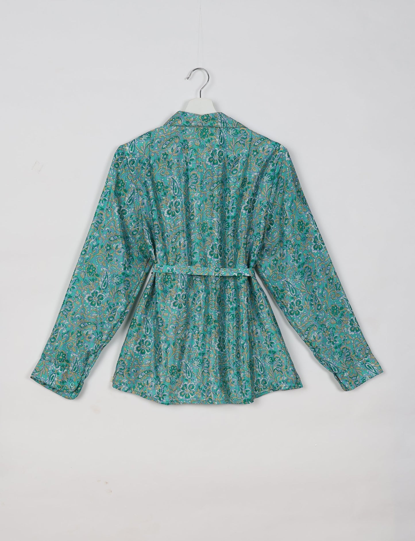 Experience sustainable fashion with our classic slim-fit shirt, crafted with ethical and green values. The shirt, designed for minimal waste, features a tie-up waist belt or neck tie, semi-spread collar, and regular shirt cuffs. Versatile and eco-friendly, wear it tucked in, unbuttoned over a tank top, or knotted at the waist for a unique style.