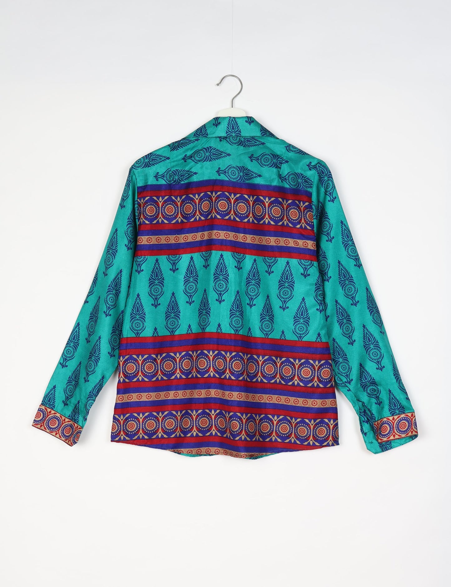 Experience sustainable fashion with our classic slim-fit shirt, crafted with ethical and green values. The shirt, designed for minimal waste, features a tie-up waist belt or neck tie, semi-spread collar, and regular shirt cuffs. Versatile and eco-friendly, wear it tucked in, unbuttoned over a tank top, or knotted at the waist for a unique style.