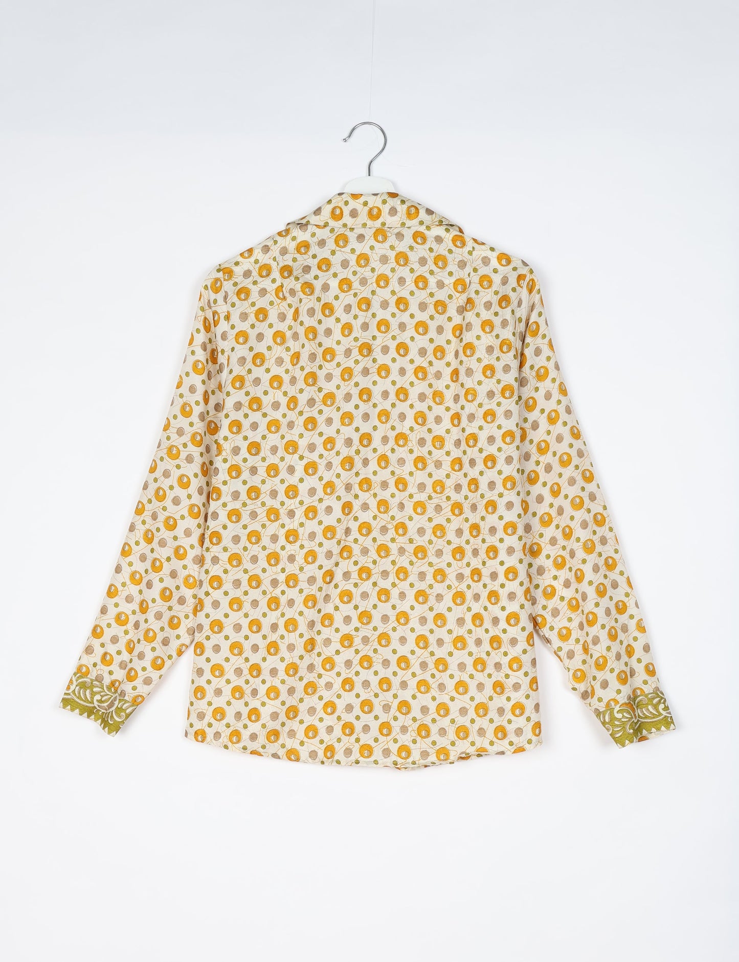 Experience sustainable fashion with our classic slim-fit shirt, crafted with ethical and green values. The shirt, designed for minimal waste, features a tie-up waist belt or neck tie, semi-spread collar, and regular shirt cuffs. Versatile and eco-friendly, wear it tucked in, unbuttoned over a tank top, or knotted at the waist for a unique style.