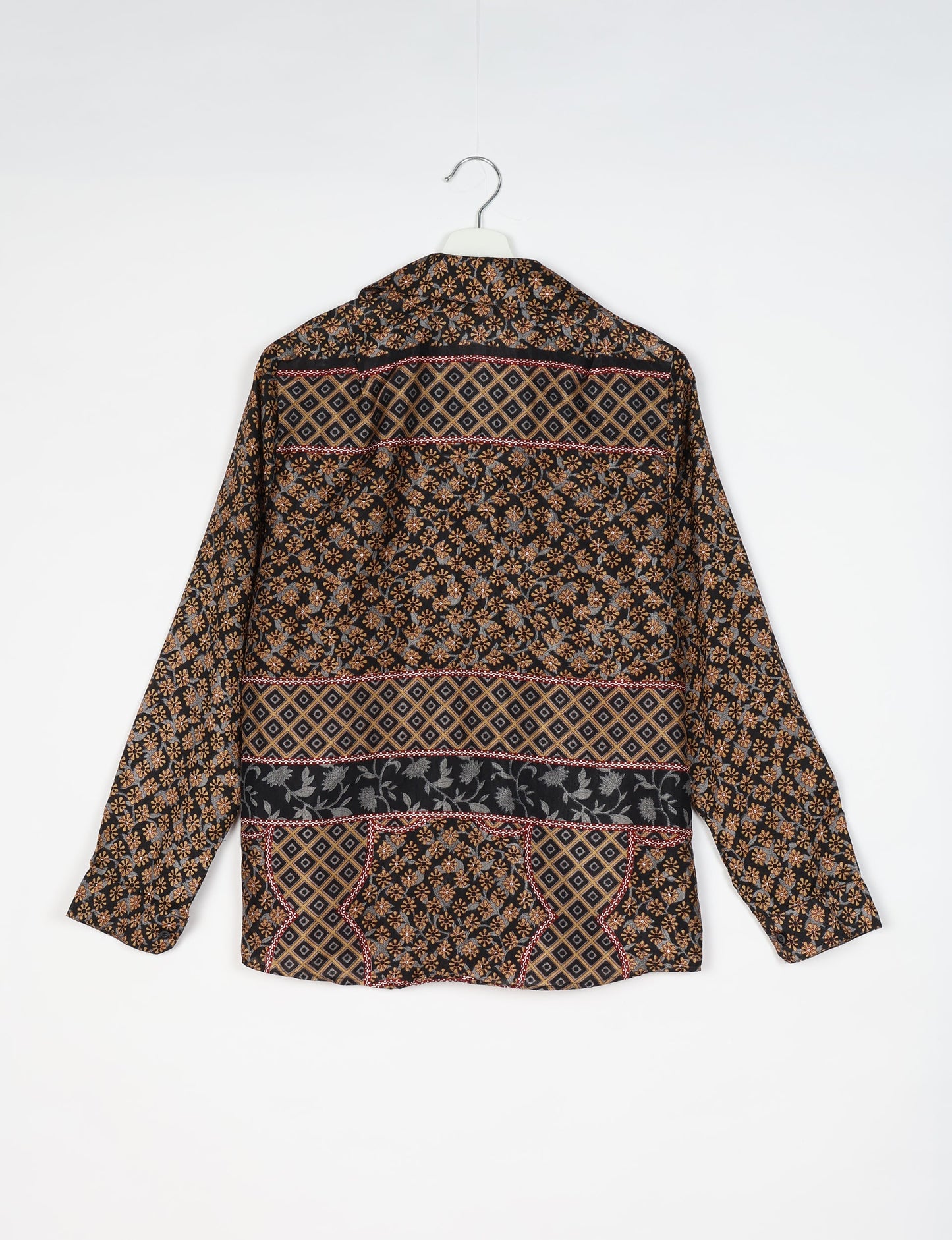 Experience sustainable fashion with our classic slim-fit shirt, crafted with ethical and green values. The shirt, designed for minimal waste, features a tie-up waist belt or neck tie, semi-spread collar, and regular shirt cuffs. Versatile and eco-friendly, wear it tucked in, unbuttoned over a tank top, or knotted at the waist for a unique style.