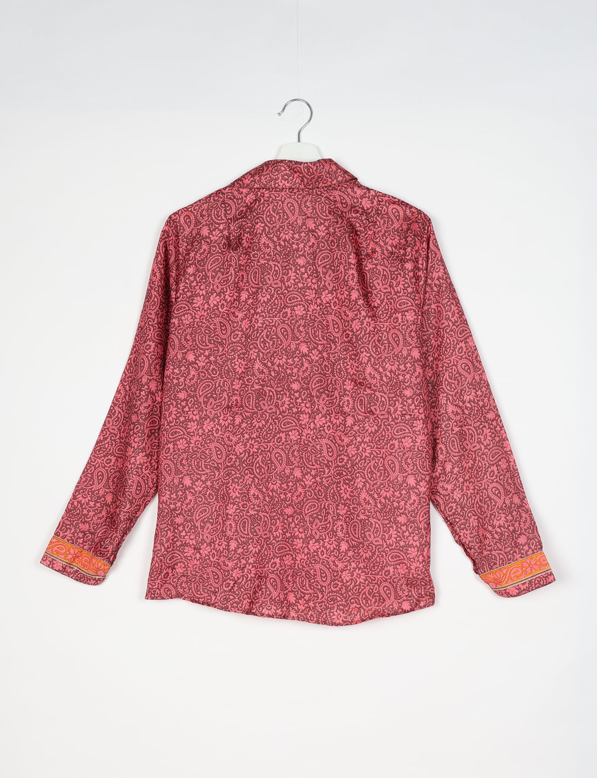 Experience sustainable fashion with our classic slim-fit shirt, crafted with ethical and green values. The shirt, designed for minimal waste, features a tie-up waist belt or neck tie, semi-spread collar, and regular shirt cuffs. Versatile and eco-friendly, wear it tucked in, unbuttoned over a tank top, or knotted at the waist for a unique style.