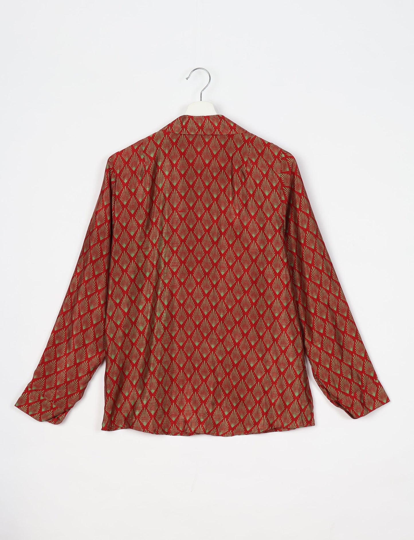 Experience sustainable fashion with our classic slim-fit shirt, crafted with ethical and green values. The shirt, designed for minimal waste, features a tie-up waist belt or neck tie, semi-spread collar, and regular shirt cuffs. Versatile and eco-friendly, wear it tucked in, unbuttoned over a tank top, or knotted at the waist for a unique style.