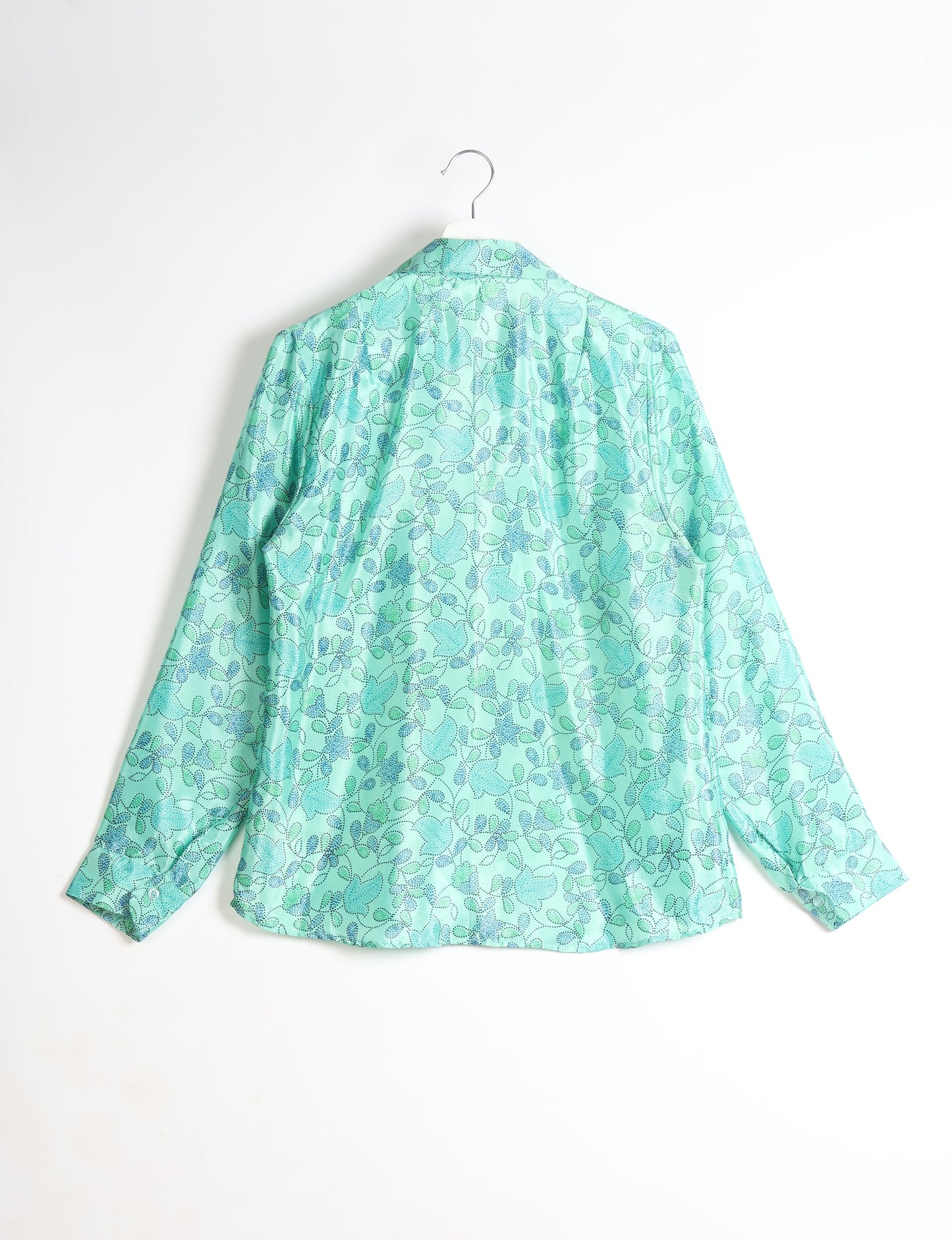 Experience sustainable fashion with our classic slim-fit shirt, crafted with ethical and green values. The shirt, designed for minimal waste, features a tie-up waist belt or neck tie, semi-spread collar, and regular shirt cuffs. Versatile and eco-friendly, wear it tucked in, unbuttoned over a tank top, or knotted at the waist for a unique style.