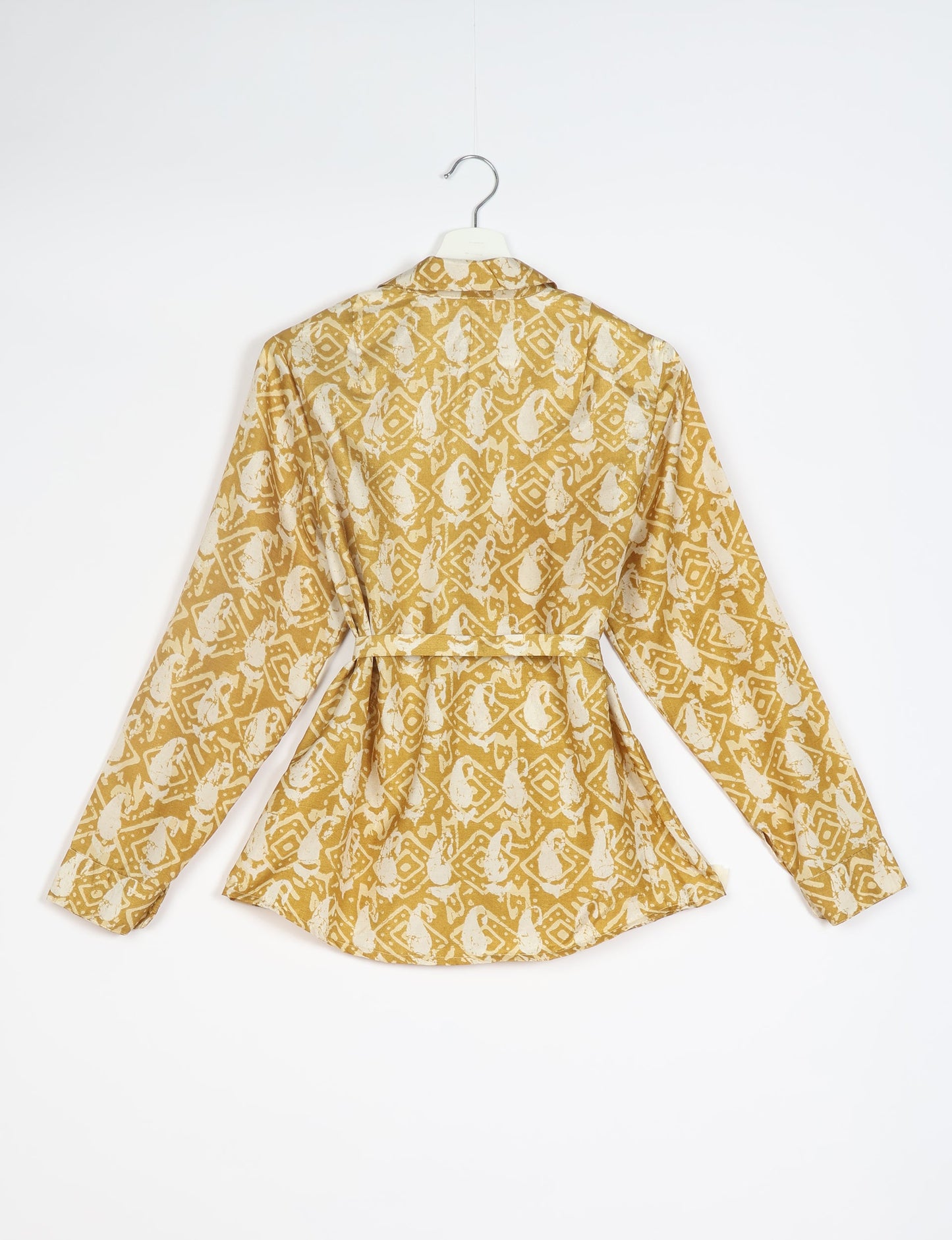 Experience sustainable fashion with our classic slim-fit shirt, crafted with ethical and green values. The shirt, designed for minimal waste, features a tie-up waist belt or neck tie, semi-spread collar, and regular shirt cuffs. Versatile and eco-friendly, wear it tucked in, unbuttoned over a tank top, or knotted at the waist for a unique style.