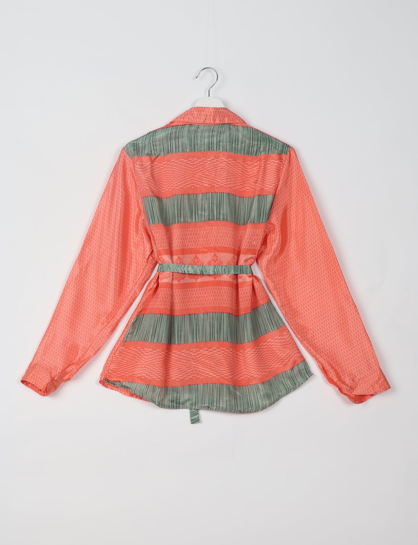 Experience sustainable fashion with our classic slim-fit shirt, crafted with ethical and green values. The shirt, designed for minimal waste, features a tie-up waist belt or neck tie, semi-spread collar, and regular shirt cuffs. Versatile and eco-friendly, wear it tucked in, unbuttoned over a tank top, or knotted at the waist for a unique style.