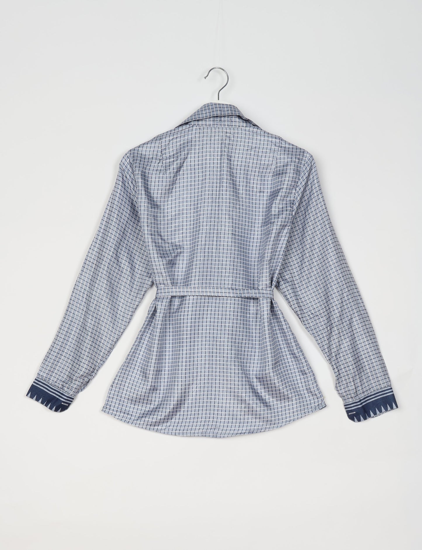 Experience sustainable fashion with our classic slim-fit shirt, crafted with ethical and green values. The shirt, designed for minimal waste, features a tie-up waist belt or neck tie, semi-spread collar, and regular shirt cuffs. Versatile and eco-friendly, wear it tucked in, unbuttoned over a tank top, or knotted at the waist for a unique style.