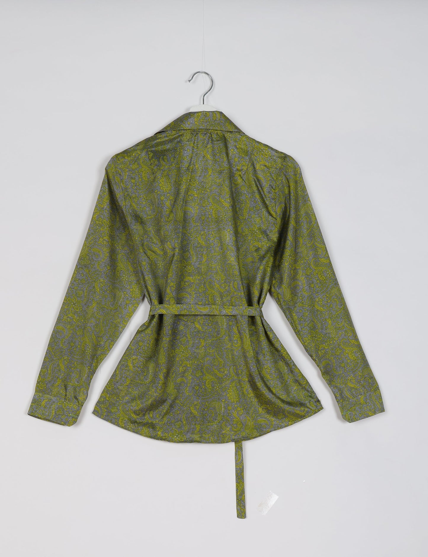 Experience sustainable fashion with our classic slim-fit shirt, crafted with ethical and green values. The shirt, designed for minimal waste, features a tie-up waist belt or neck tie, semi-spread collar, and regular shirt cuffs. Versatile and eco-friendly, wear it tucked in, unbuttoned over a tank top, or knotted at the waist for a unique style.