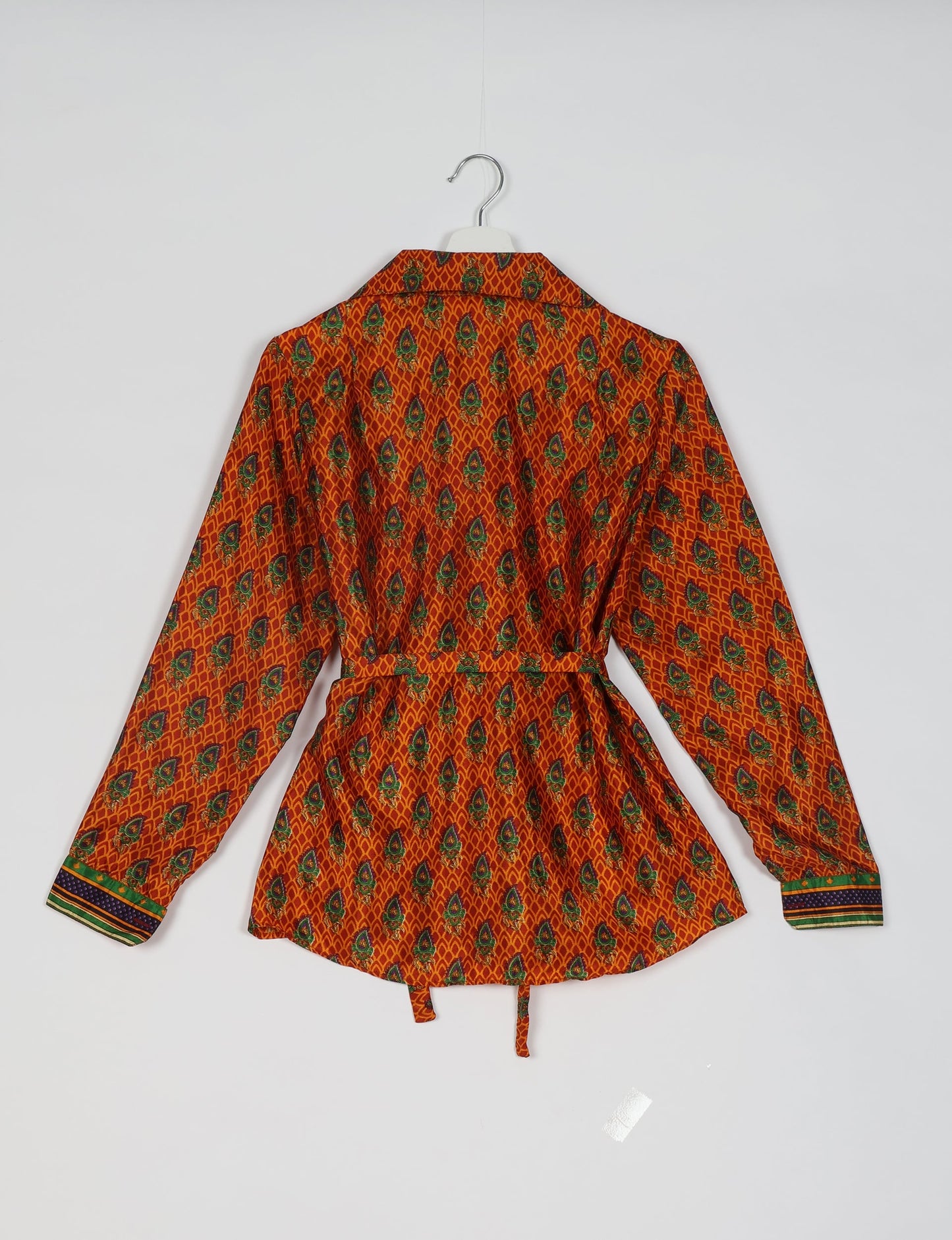 Experience sustainable fashion with our classic slim-fit shirt, crafted with ethical and green values. The shirt, designed for minimal waste, features a tie-up waist belt or neck tie, semi-spread collar, and regular shirt cuffs. Versatile and eco-friendly, wear it tucked in, unbuttoned over a tank top, or knotted at the waist for a unique style.