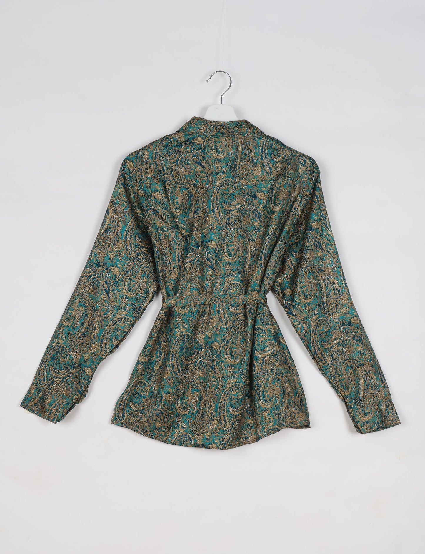 Experience sustainable fashion with our classic slim-fit shirt, crafted with ethical and green values. The shirt, designed for minimal waste, features a tie-up waist belt or neck tie, semi-spread collar, and regular shirt cuffs. Versatile and eco-friendly, wear it tucked in, unbuttoned over a tank top, or knotted at the waist for a unique style.