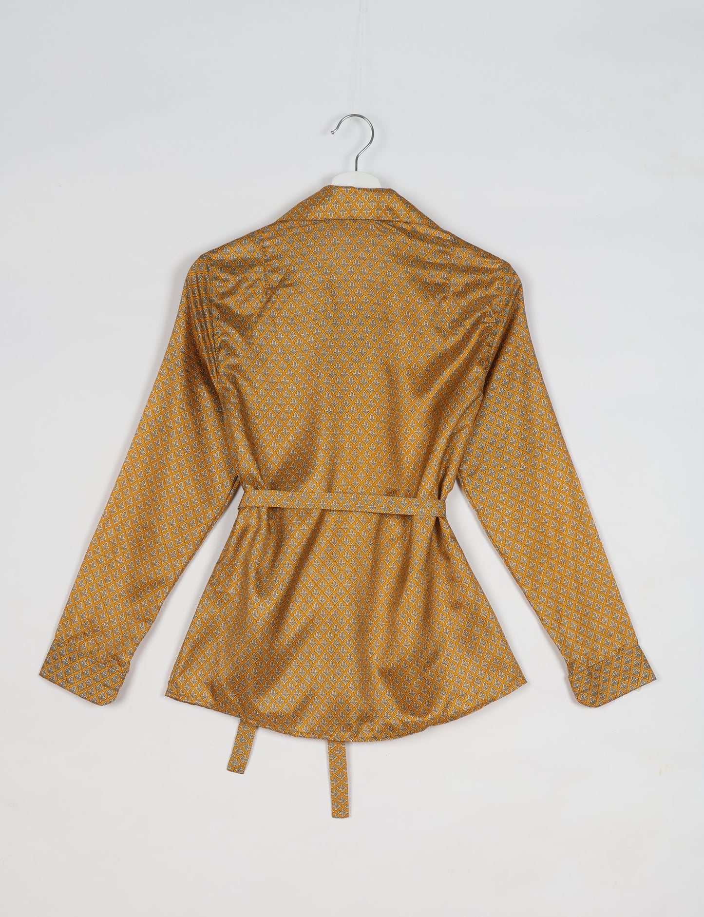 Experience sustainable fashion with our classic slim-fit shirt, crafted with ethical and green values. The shirt, designed for minimal waste, features a tie-up waist belt or neck tie, semi-spread collar, and regular shirt cuffs. Versatile and eco-friendly, wear it tucked in, unbuttoned over a tank top, or knotted at the waist for a unique style.