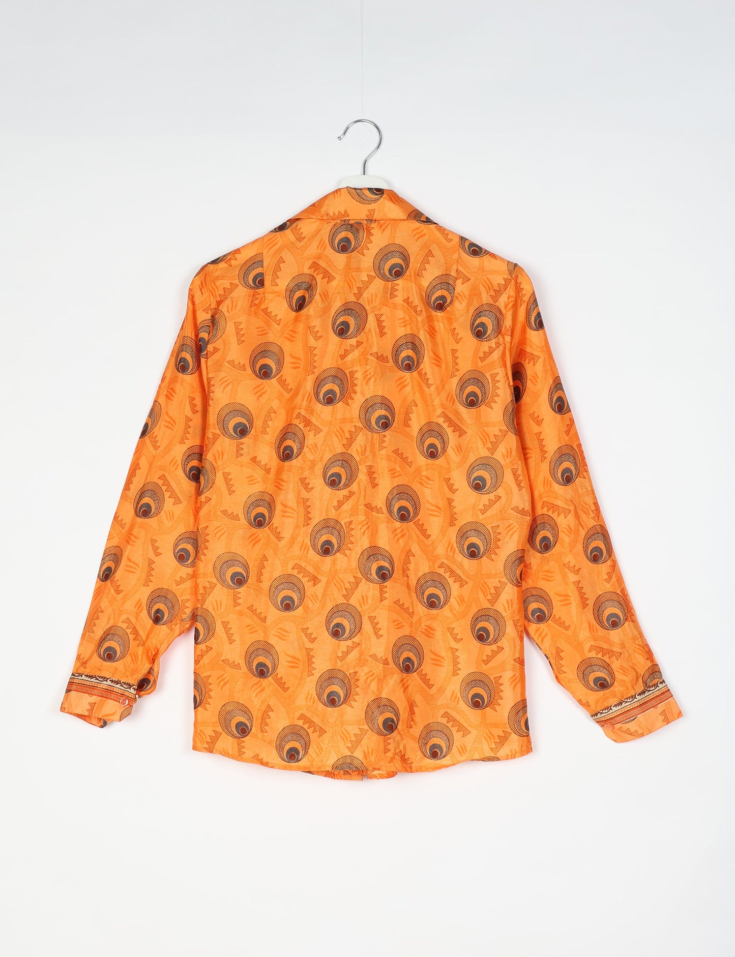 Experience sustainable fashion with our classic slim-fit shirt, crafted with ethical and green values. The shirt, designed for minimal waste, features a tie-up waist belt or neck tie, semi-spread collar, and regular shirt cuffs. Versatile and eco-friendly, wear it tucked in, unbuttoned over a tank top, or knotted at the waist for a unique style.