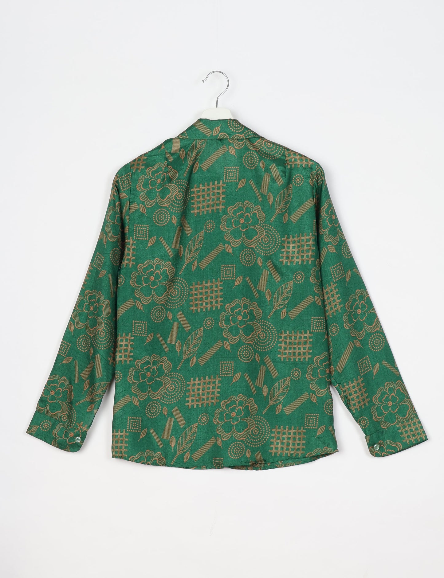 Experience sustainable fashion with our classic slim-fit shirt, crafted with ethical and green values. The shirt, designed for minimal waste, features a tie-up waist belt or neck tie, semi-spread collar, and regular shirt cuffs. Versatile and eco-friendly, wear it tucked in, unbuttoned over a tank top, or knotted at the waist for a unique style.